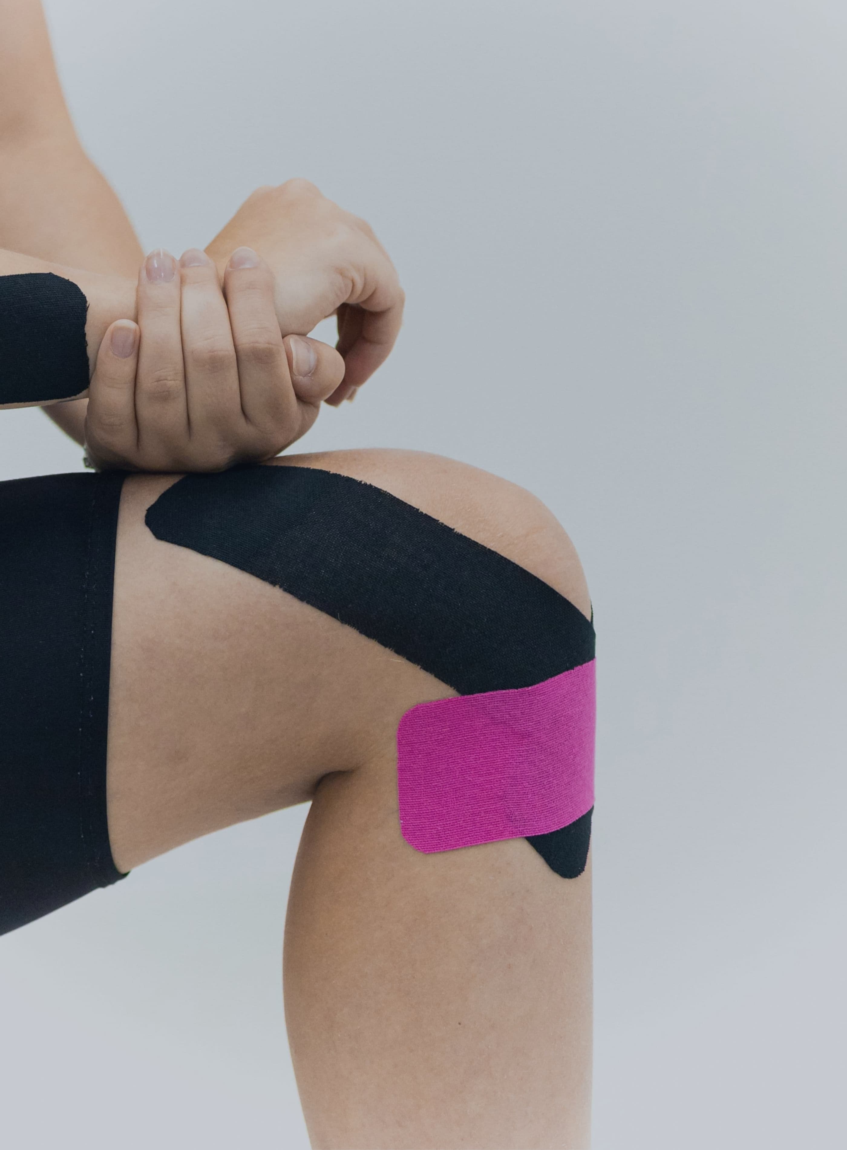 knee with sports tape across the kneecap