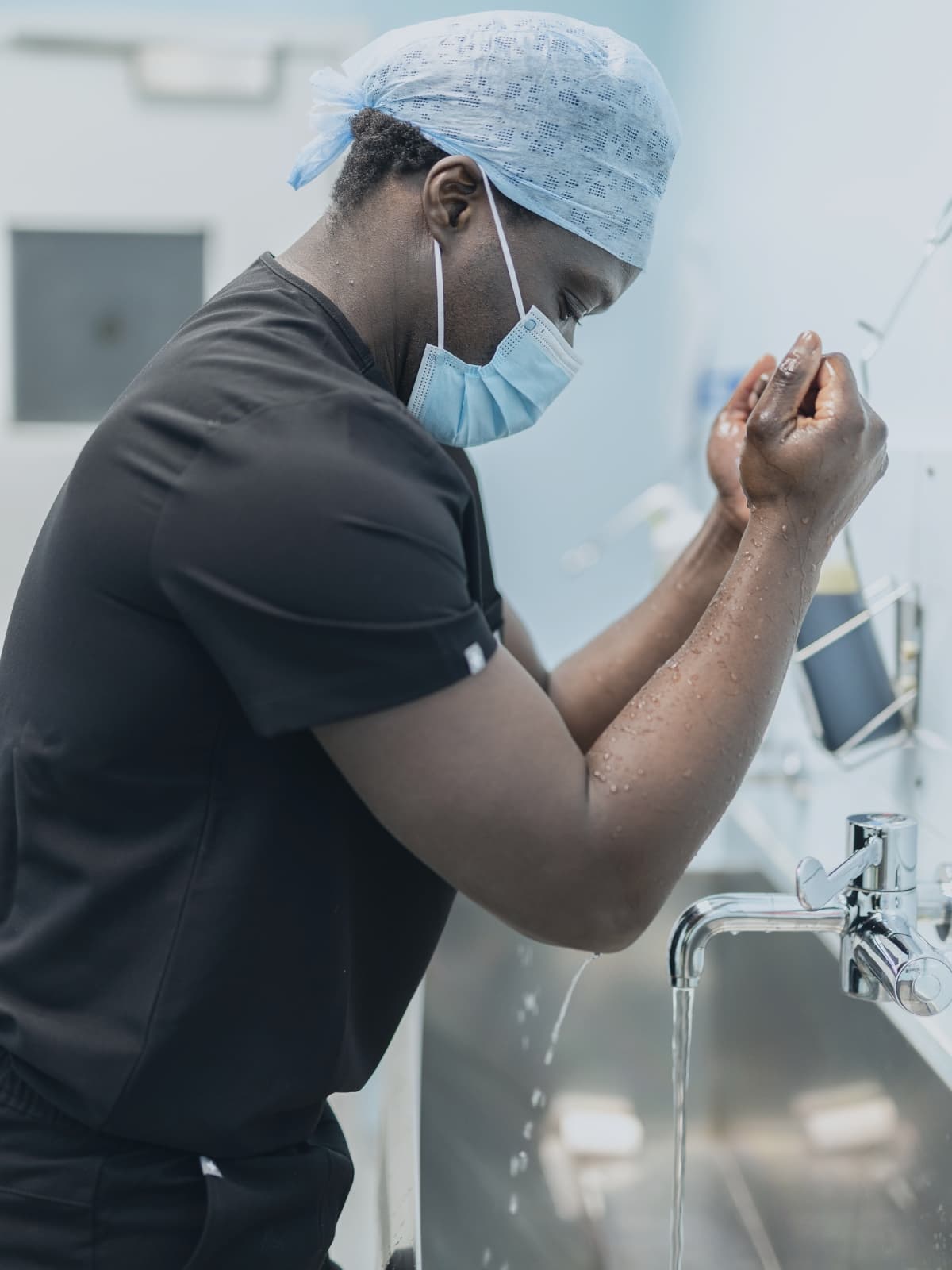 Mr oni scrubbing up for surgery wearing surgical scrubs