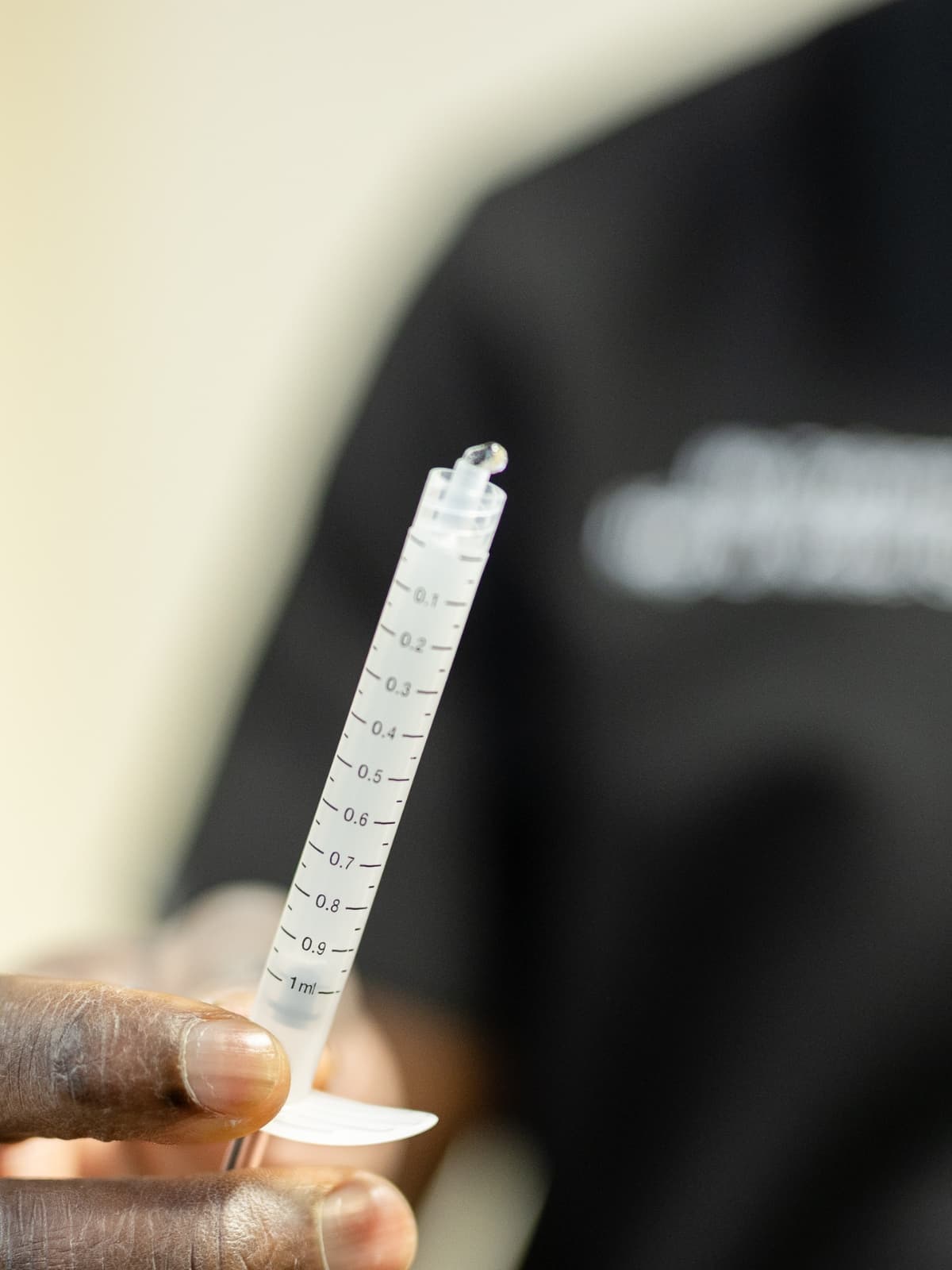 Mr Oni holding up a syringe of arthrosomid close to the camera