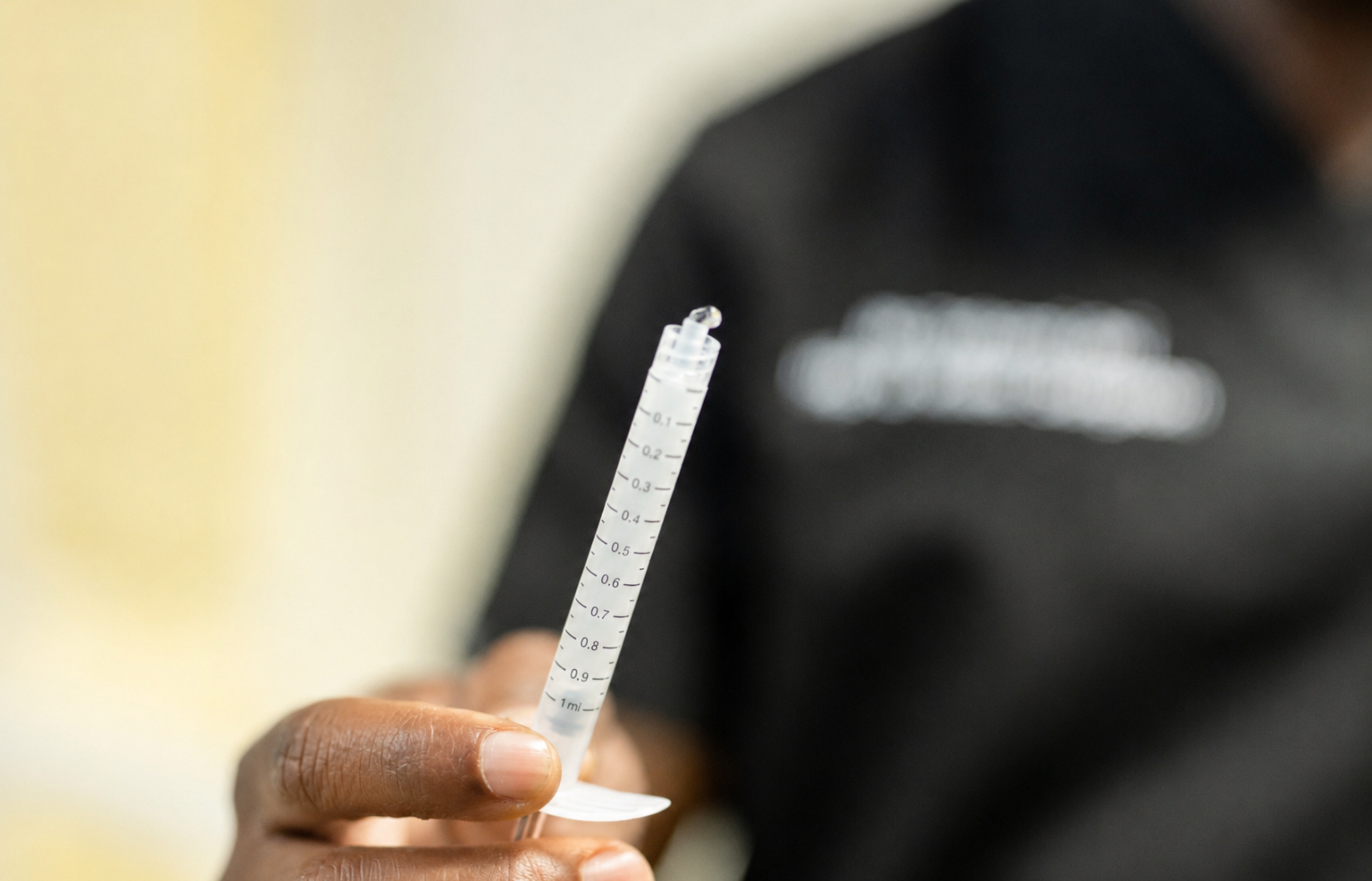 Mr Oni holding up a syringe of arthrosomid close to the camera