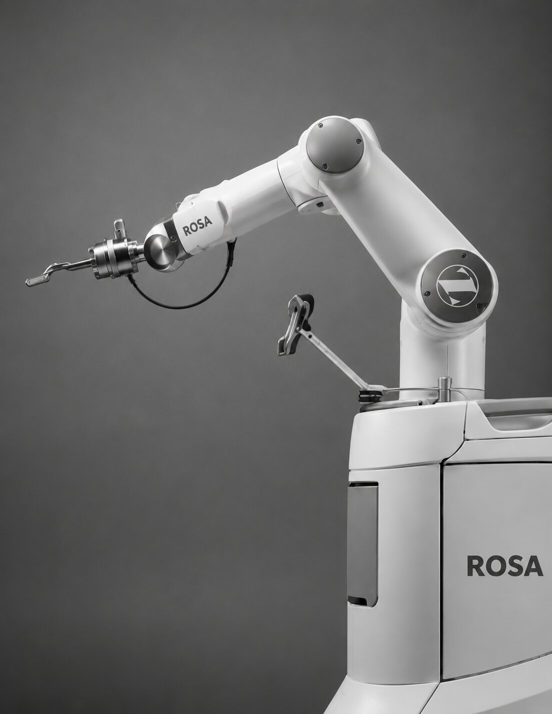 side view of Rosa surgery robot, black and white image with the robot facing to the left of the image.