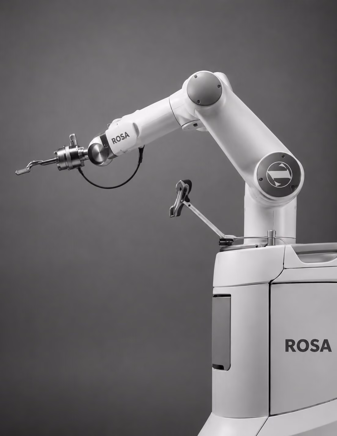 side view of Rosa surgery robot, black and white image with the robot facing to the left of the image.