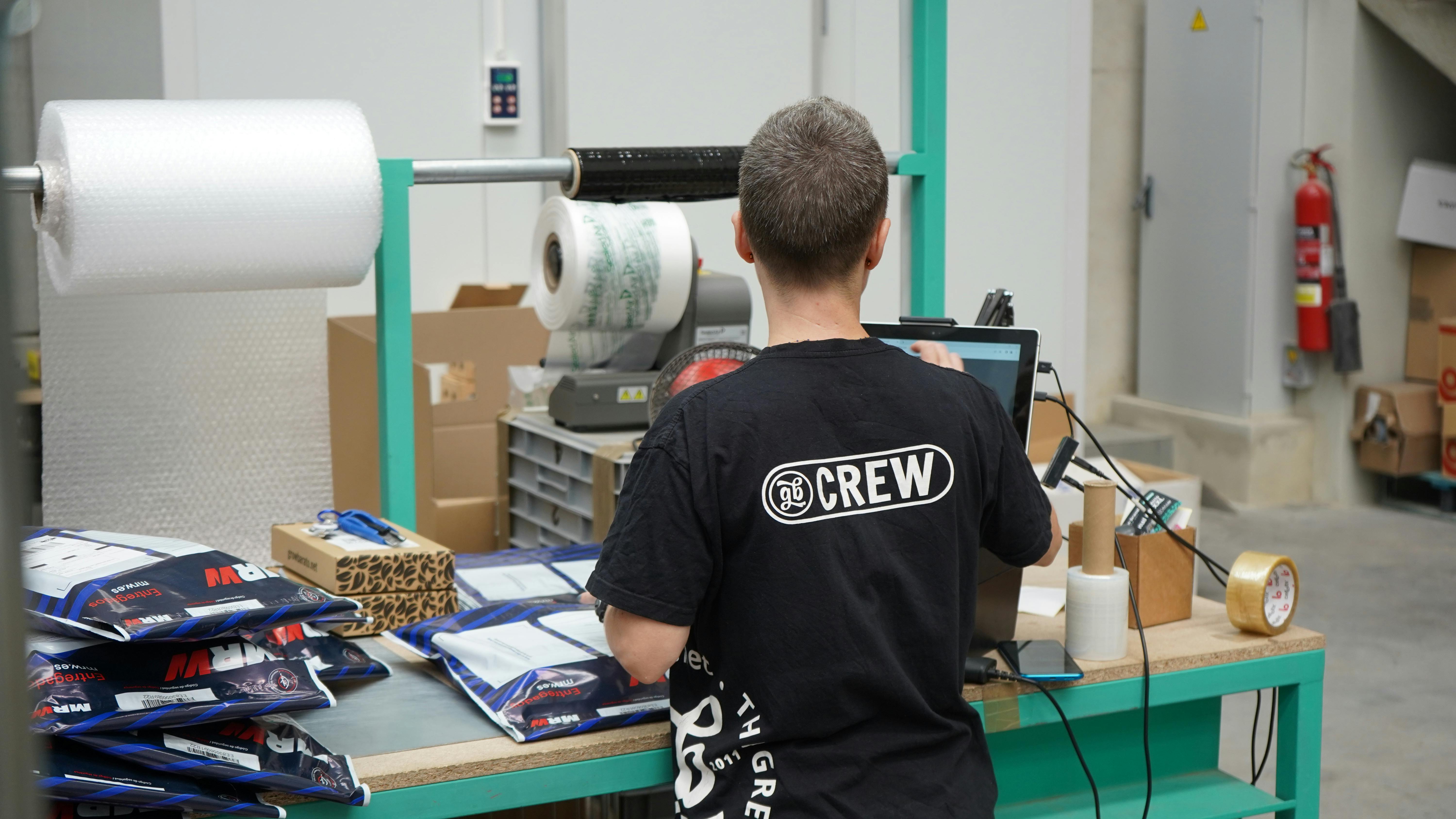 Shop floor operator in a warehouse printing labels for shipment