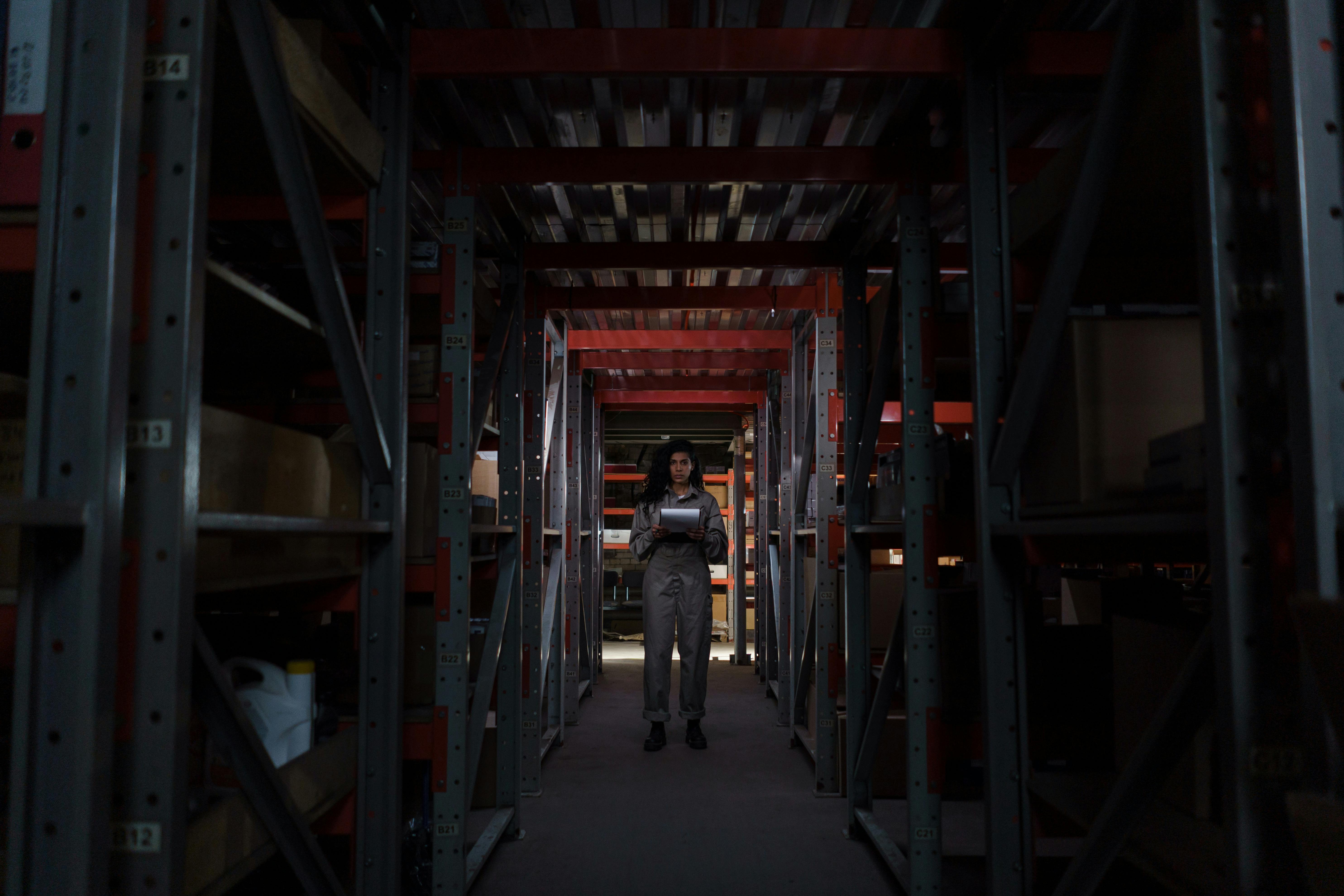 Worker checking for an item in a specific location in the warehouse