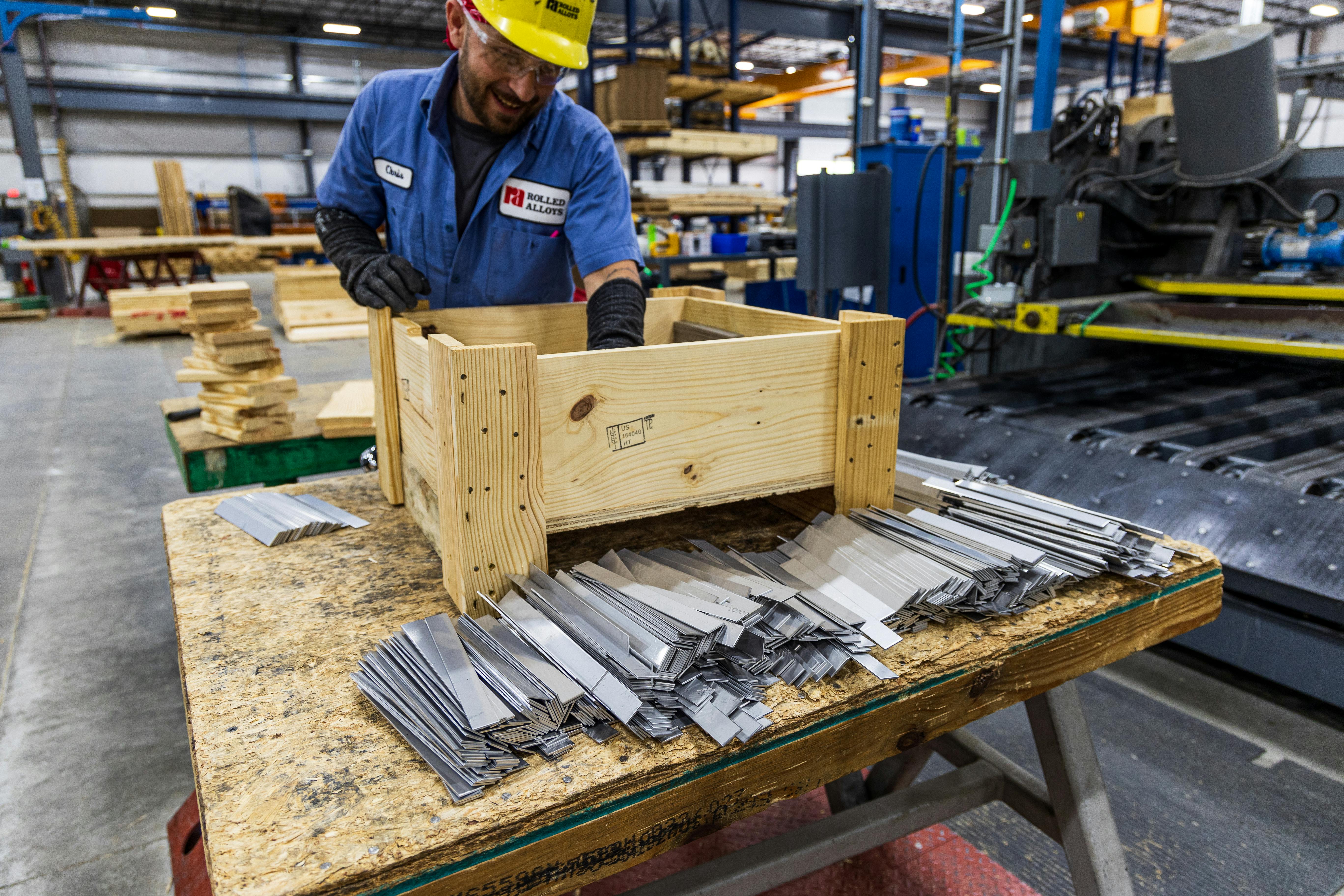 Factory floor showing an assembly line with work operating at different stations.