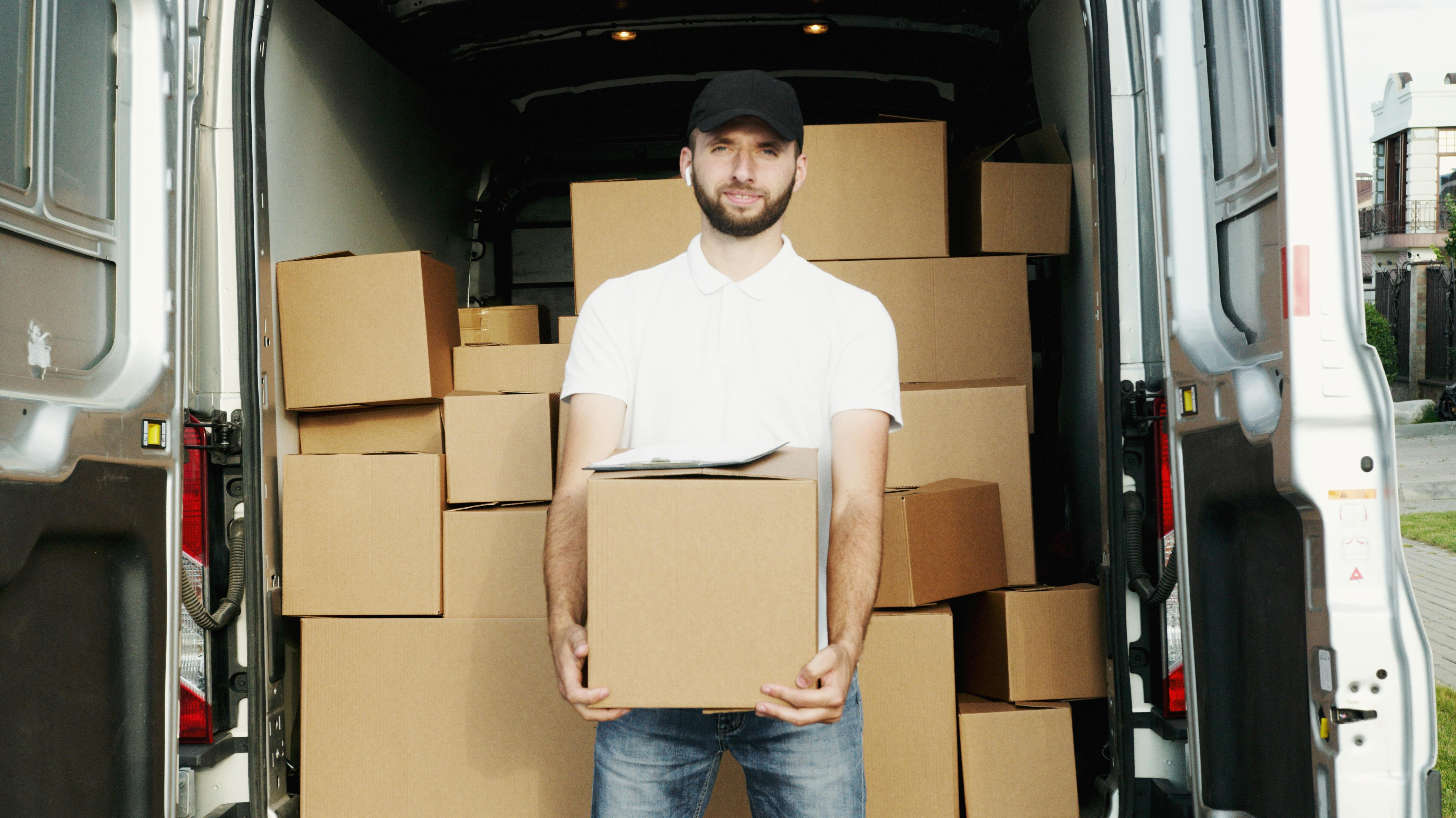 boxes stacked and a delivery truck visible in the background.