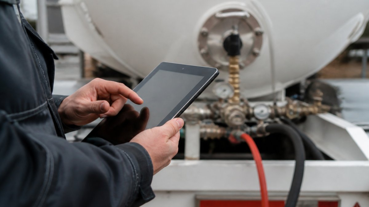 person using technology to enter field data from truck
