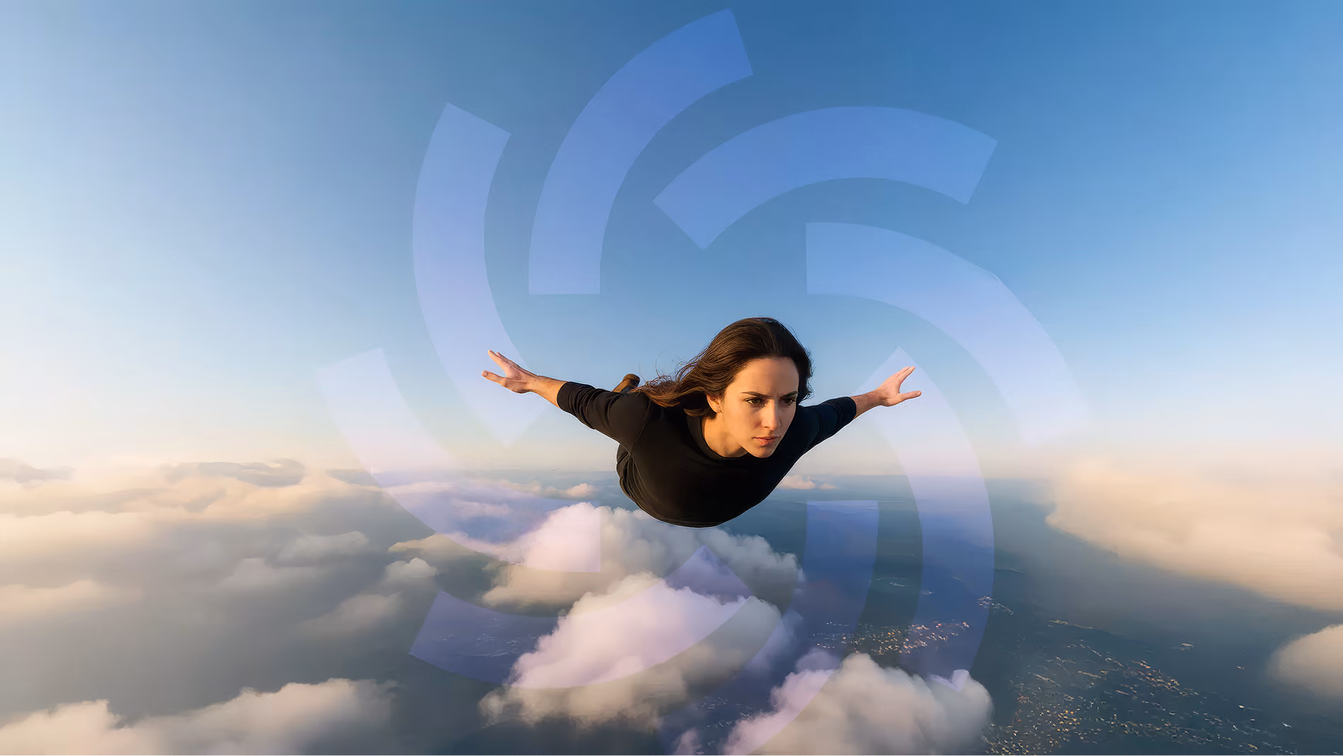 Woman in black outfit with arms extended appears to be flying above clouds against a clear blue sky during sunset or sunrise.