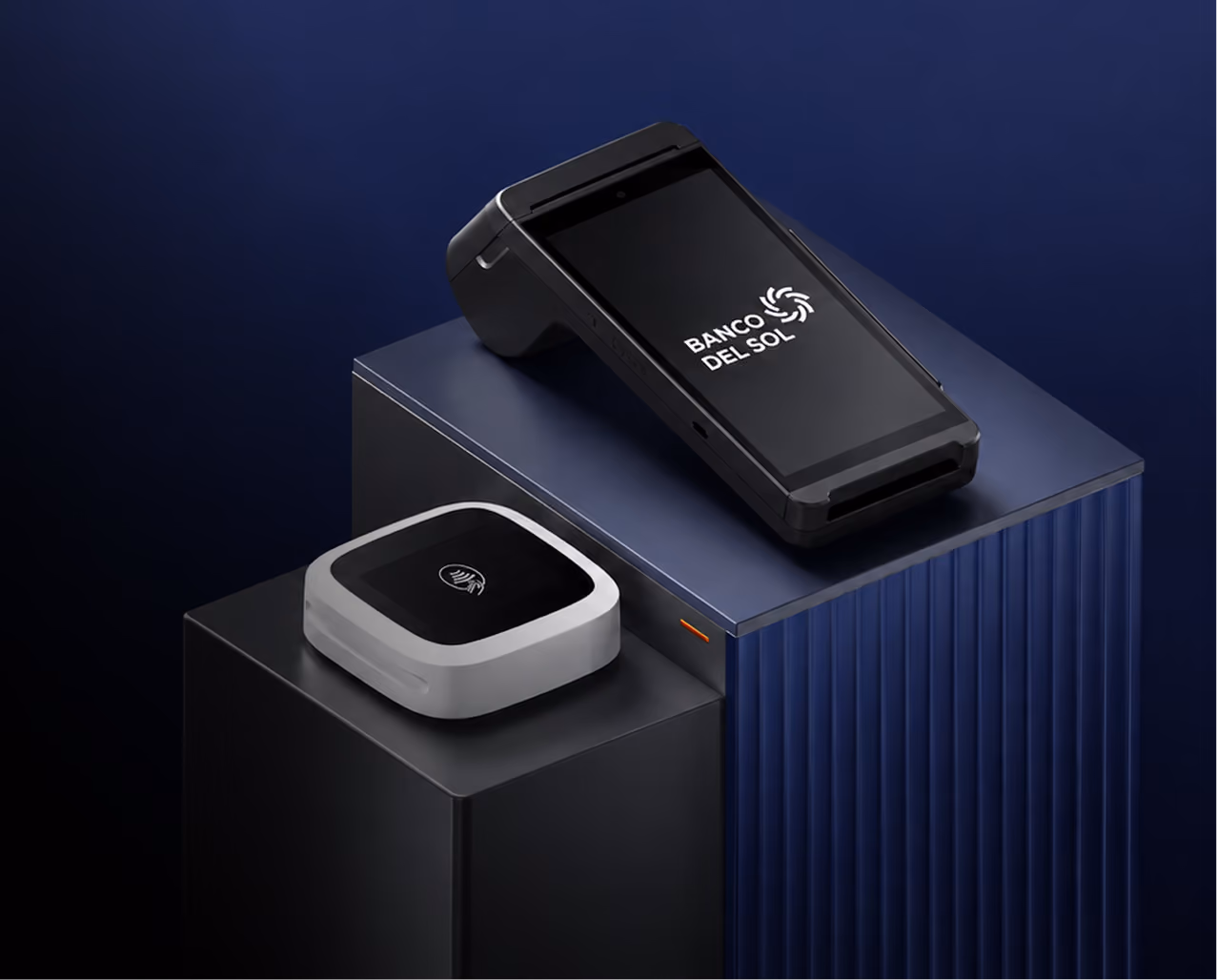 Two point-of-sale devices on black and blue podiums against a dark blue background; one is a black handheld terminal displaying the Banco Del Sol logo, and the other is a white contactless card reader with a wireless symbol on top.