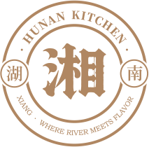 Logo featuring a circular emblem with the large stylized Chinese character '湘' in the center, surrounded by smaller Chinese characters '湘南' and English text 'Human Kitchen' at the top and 'Xiang - Xiang River Meets Flavor' at the bottom.