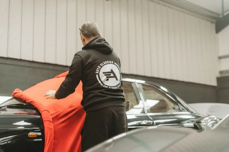 Classic car under a breathable cover in dehumidified storage.