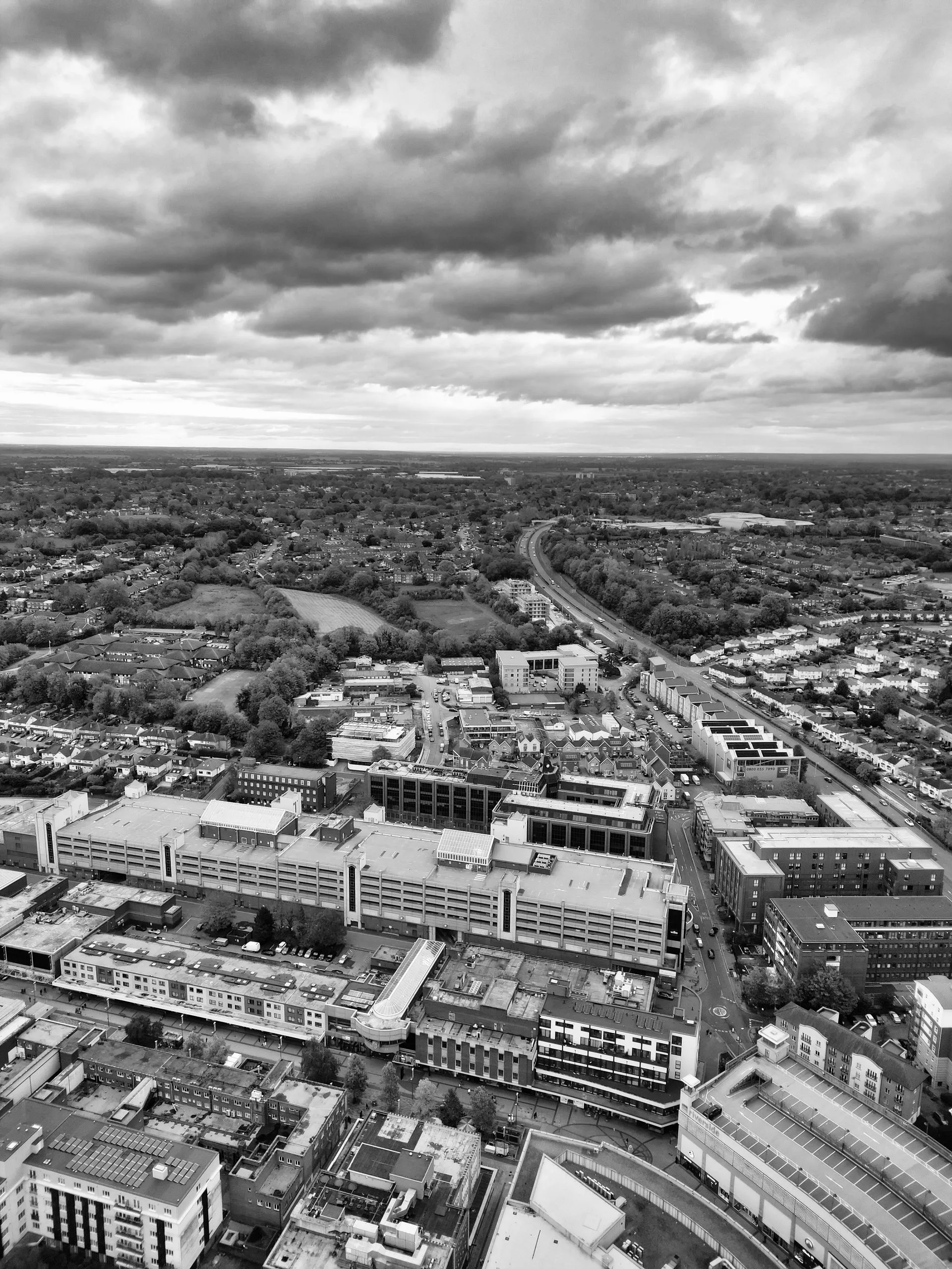 Black and white aerial view of a bustling cityscape in Hertfordshire, England