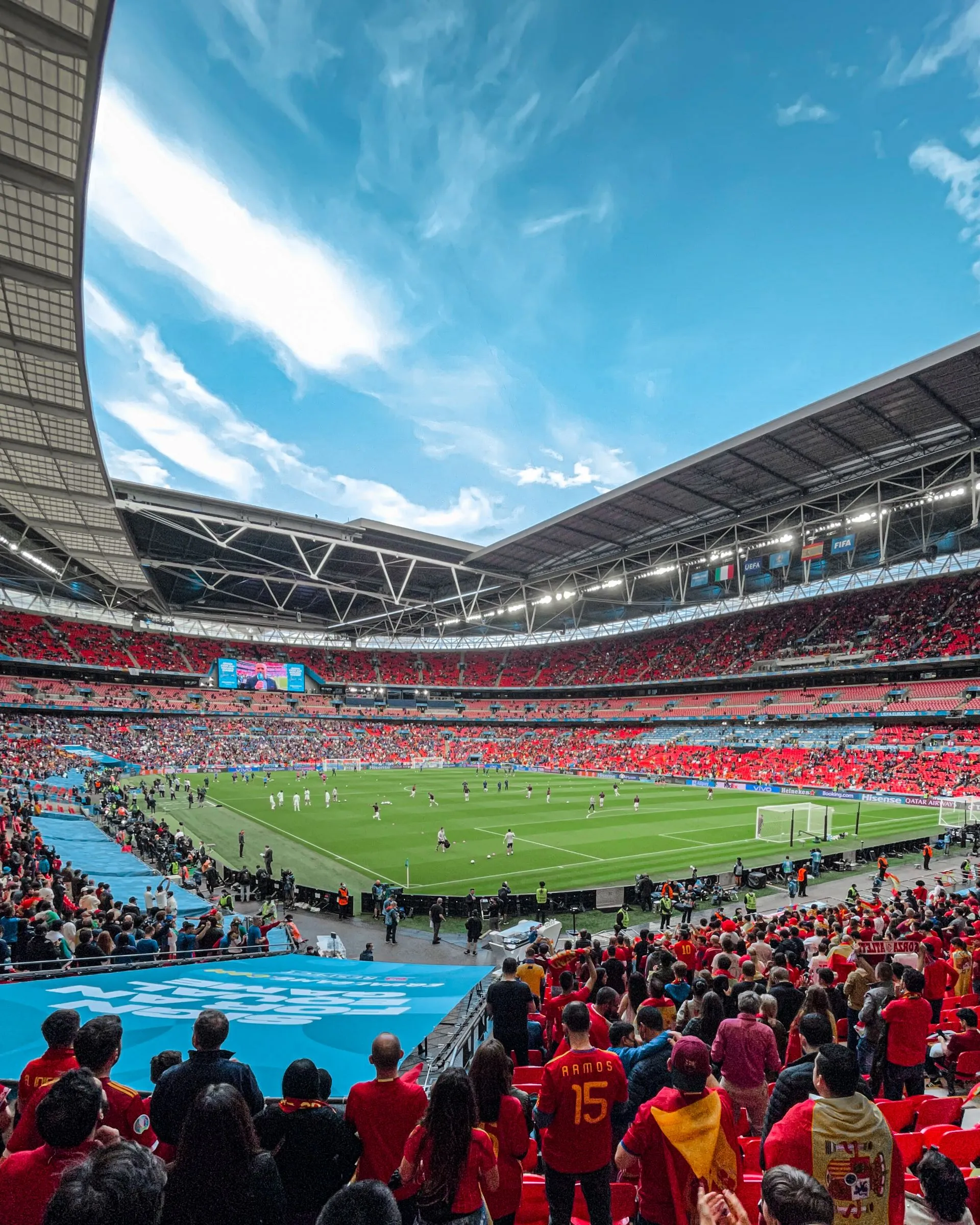 Vibrant crowd enjoys a soccer match at a bustling stadium under a clear sky