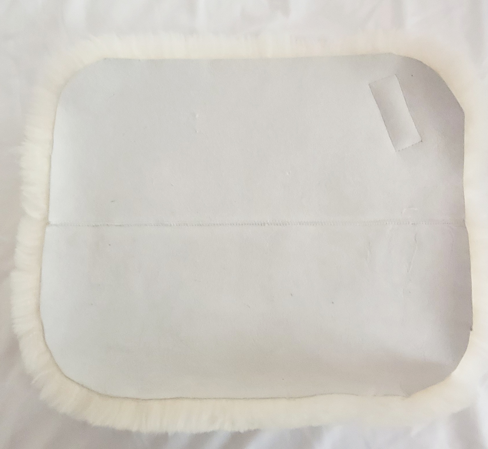 The suede backing on the underside of the Bumwarmer sheepskin seat cushion