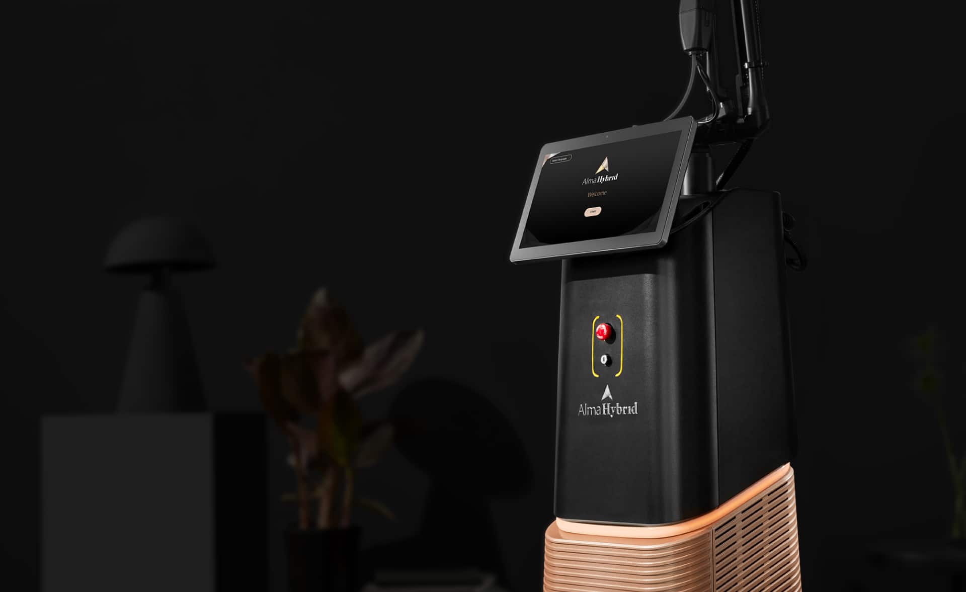 Alma Hybrid medical device with touchscreen control panel in a dimly lit room.