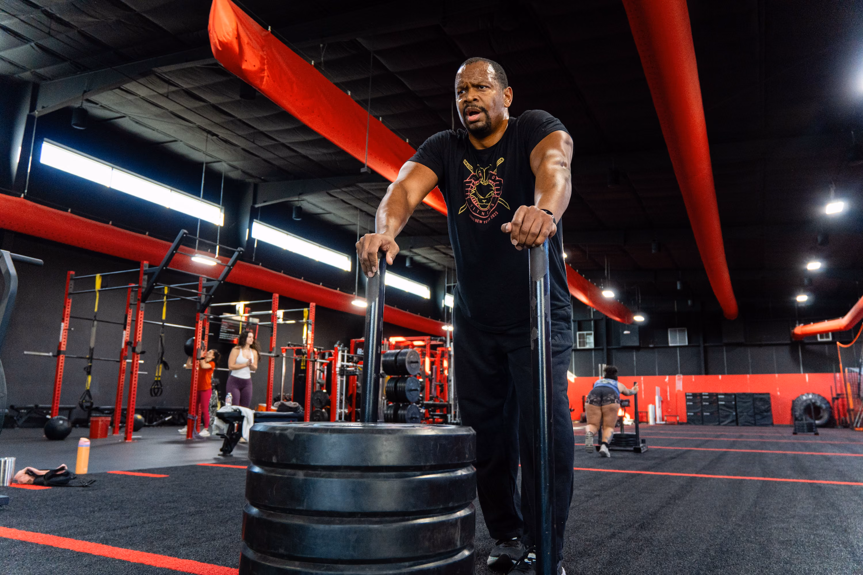 Man performing farmers carry at Kinitro Fitness.