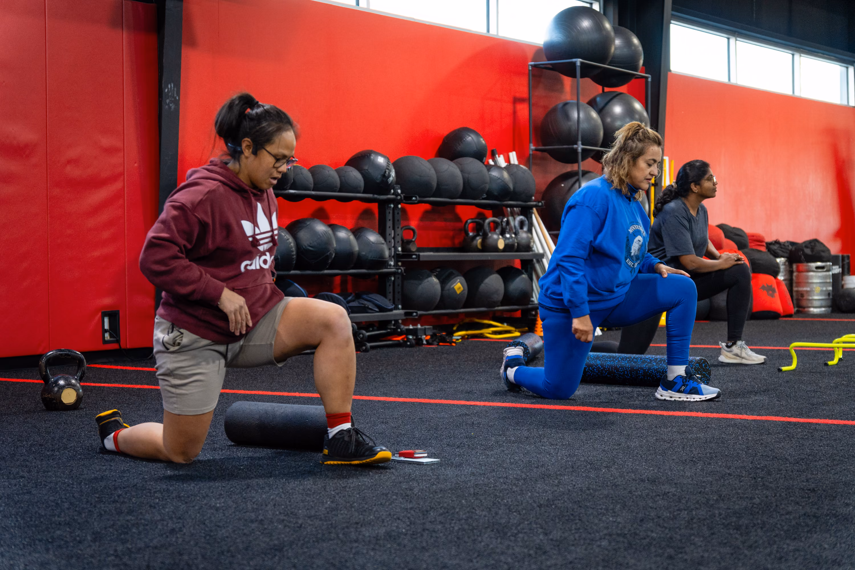 Coach guiding a client through a lunge at Kinitro Fitness