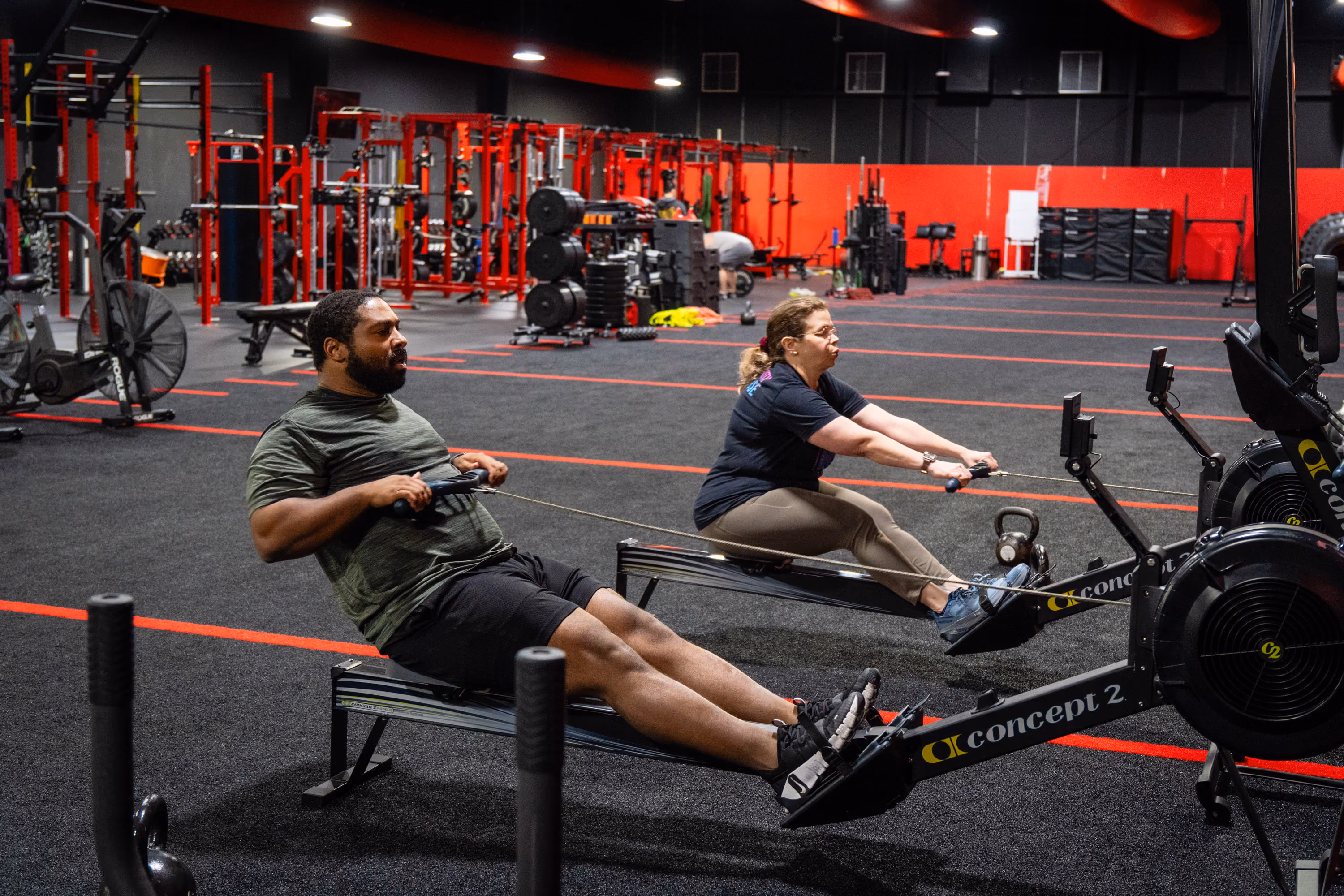 Woman performing a sled push during a coached training session at Kinitro Fitness