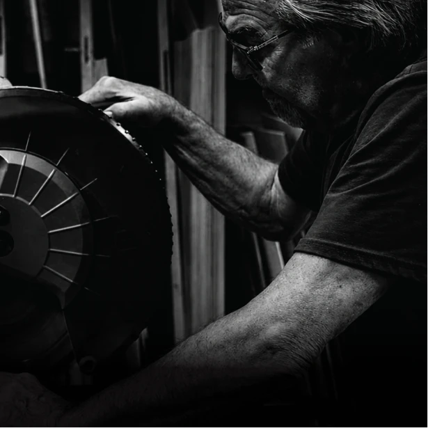 Drifter craftsperson checking a saw blade by hand in the Southfield, Michigan workshop