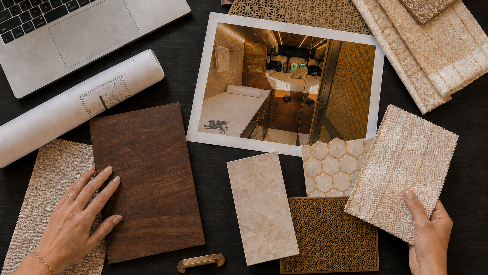 Material samples, plans, and an interior photo arranged on a designer's desk