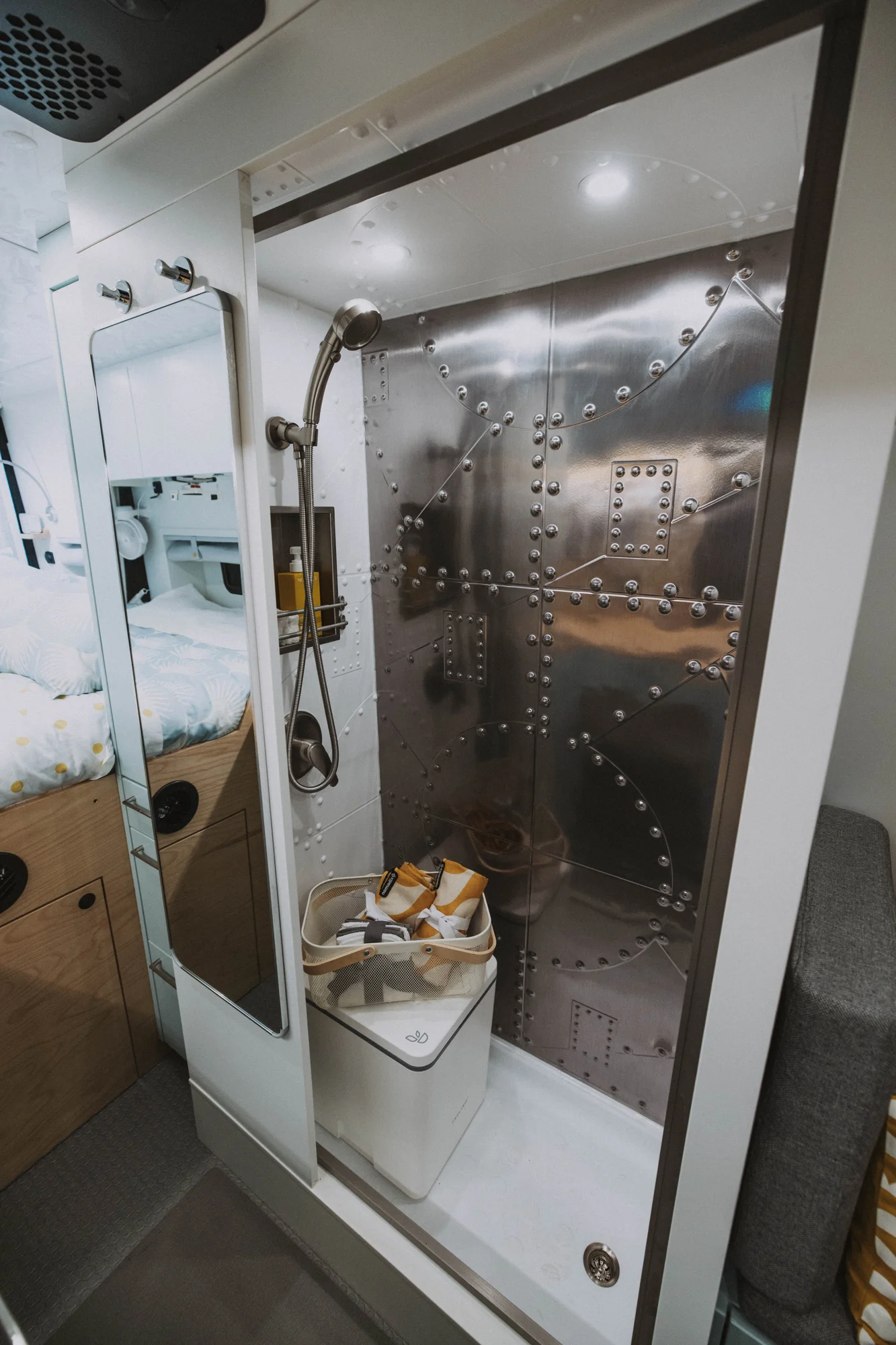 The Drifter 101 custom Ford Transit campervan built for Edward and Caroline by Drifter Vans, with Gossamer Blue Shaker cabinetry, birch butcher block countertop, Swan tile backsplash, and antique gold hardware