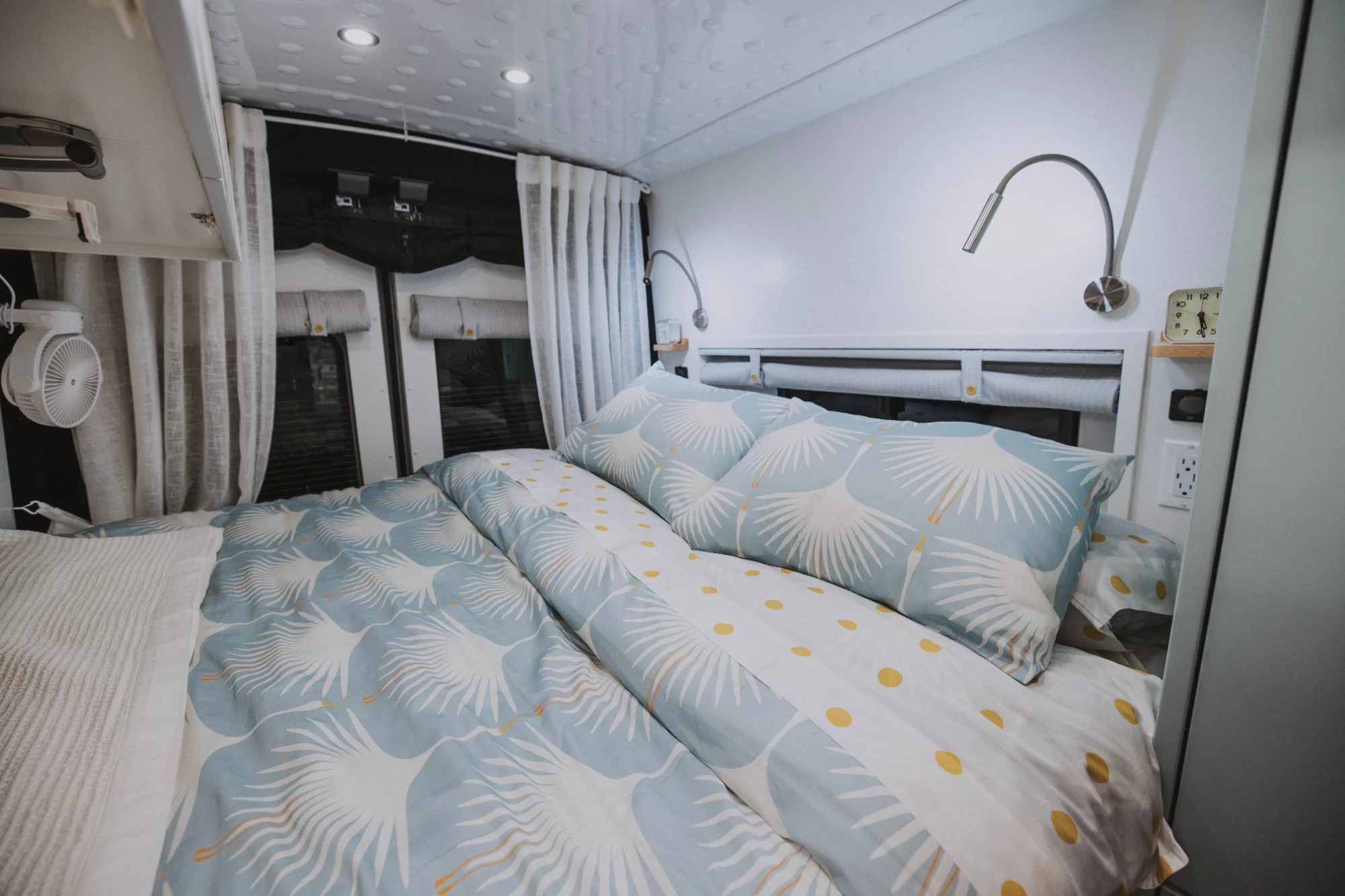 The Drifter 101 custom Ford Transit campervan built for Edward and Caroline by Drifter Vans, with Gossamer Blue Shaker cabinetry, birch butcher block countertop, Swan tile backsplash, and antique gold hardware