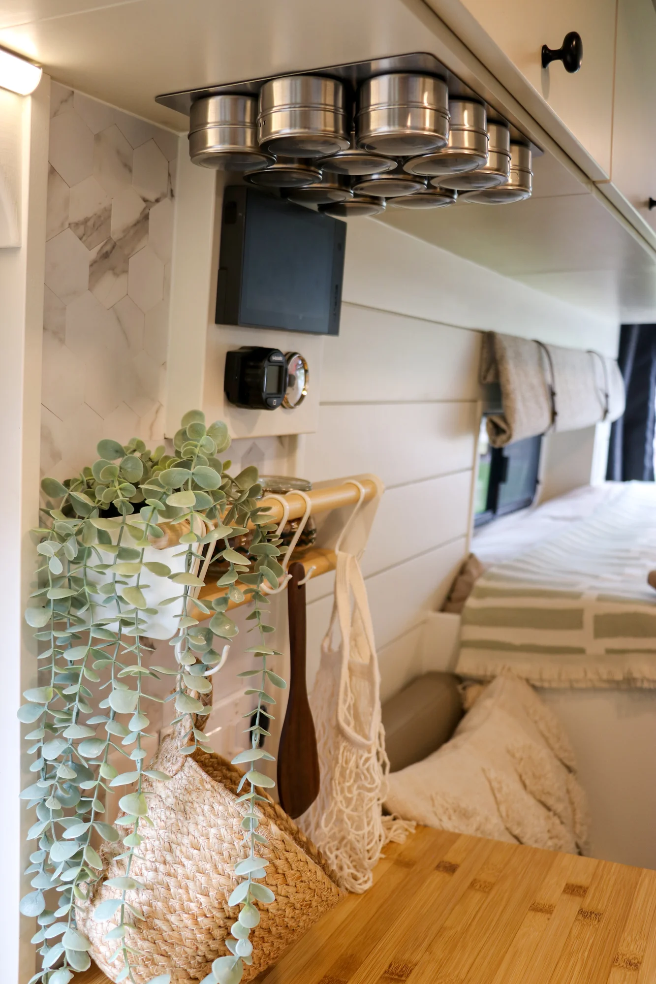 The Drifter 101 custom Ford Transit campervan built for Mallory and Matt by Drifter Vans, Nomadik layout with a bamboo countertop, matte black fixtures, marble shower, and Abyss Grey exterior