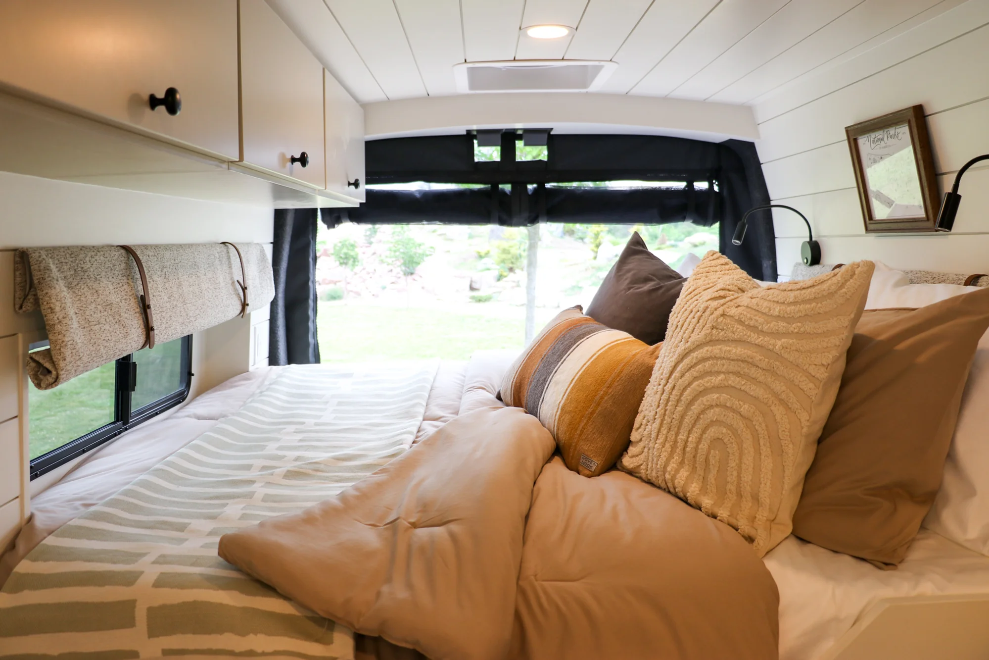 The Drifter 101 custom Ford Transit campervan built for Mallory and Matt by Drifter Vans, Nomadik layout with a bamboo countertop, matte black fixtures, marble shower, and Abyss Grey exterior