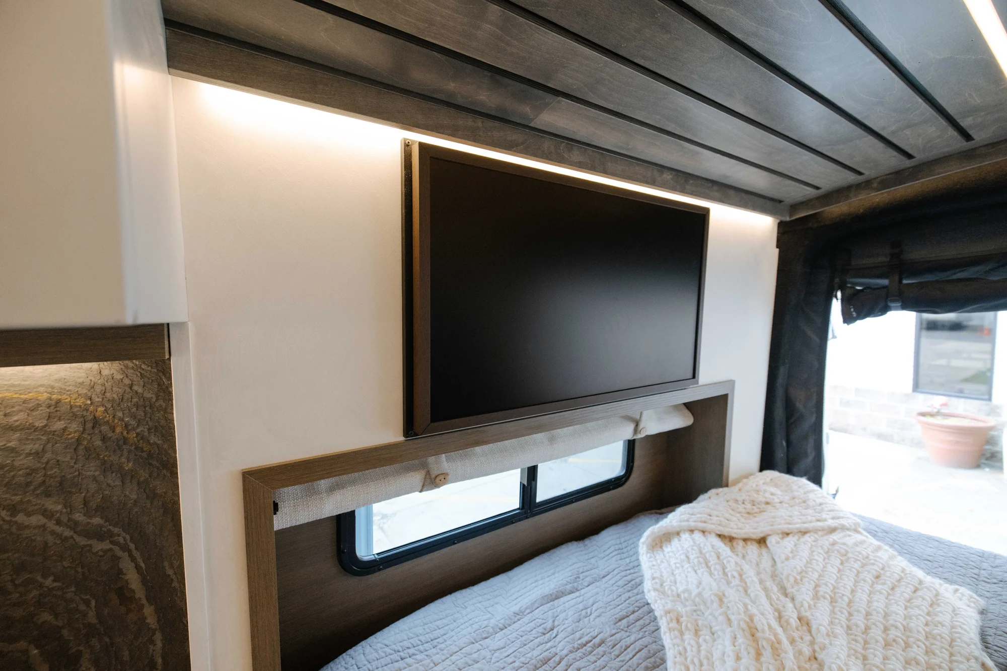 The Drifter 101 custom Ford Transit campervan built for Aron and Jamie by Drifter Vans, with GEM limewash walls, walnut countertop, an electric standing desk, and dual remote work stations