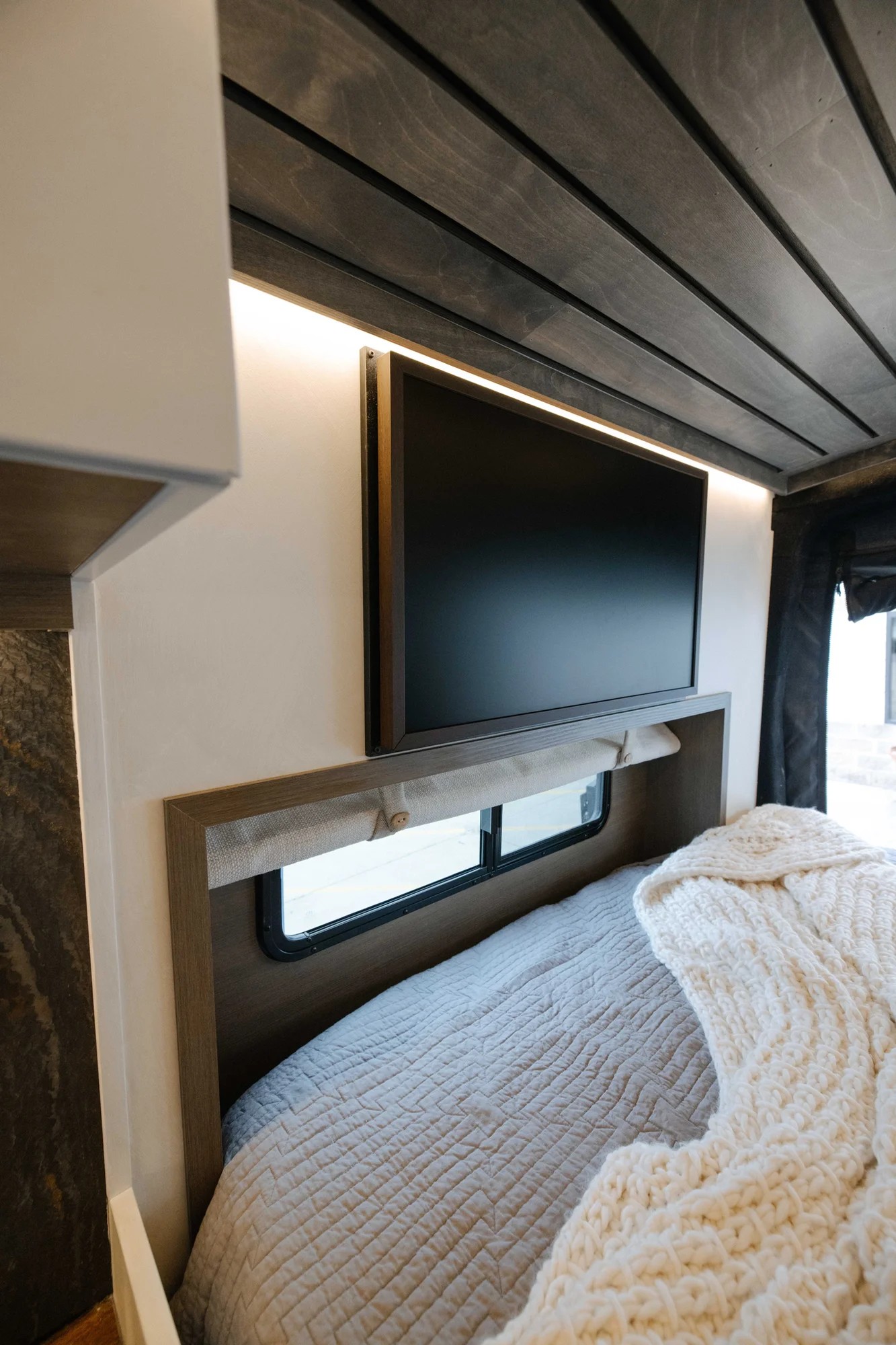 The Drifter 101 custom Ford Transit campervan built for Aron and Jamie by Drifter Vans, with GEM limewash walls, walnut countertop, an electric standing desk, and dual remote work stations