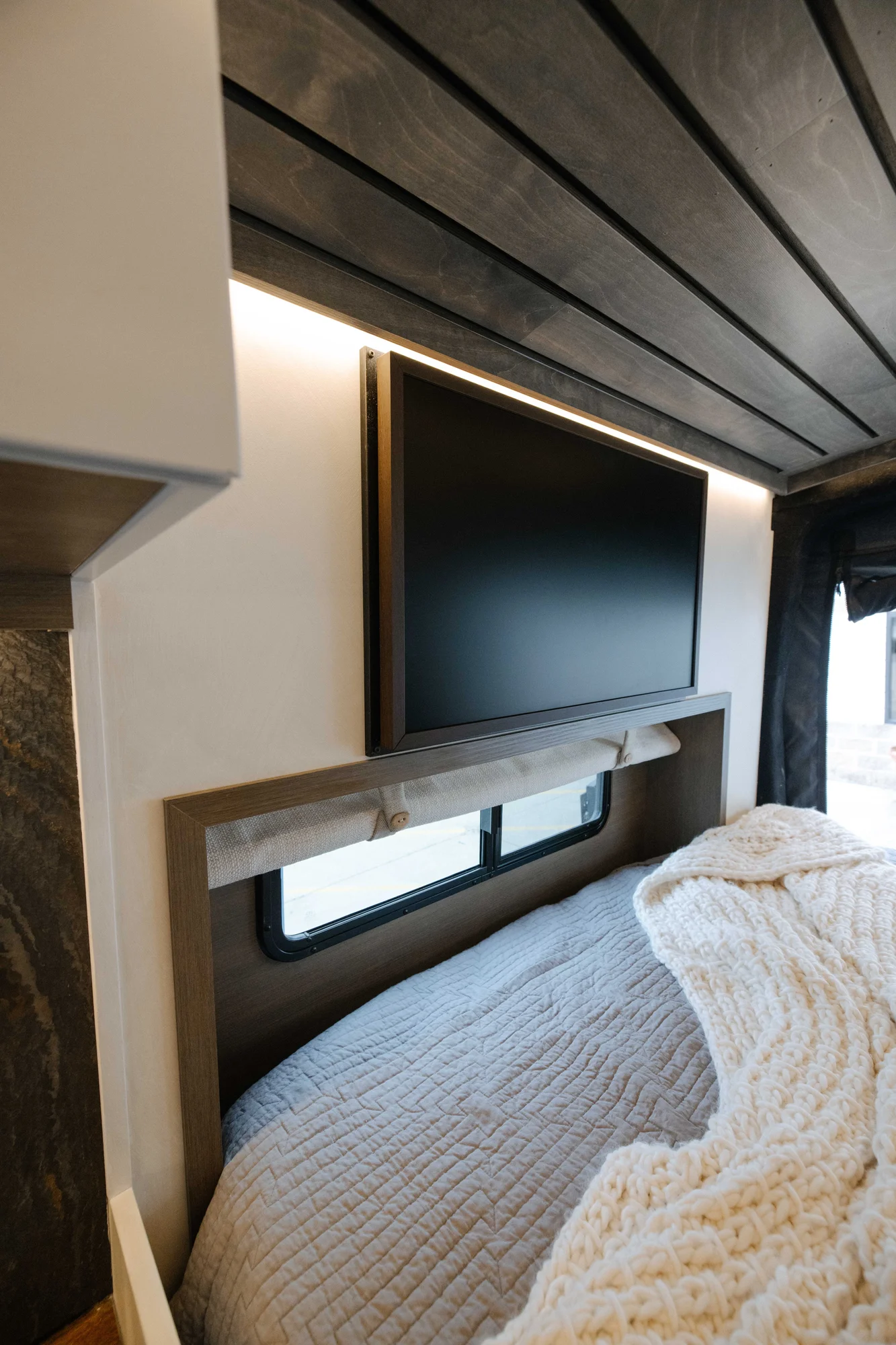 The Drifter 101 custom Ford Transit campervan built for Aron and Jamie by Drifter Vans, with GEM limewash walls, walnut countertop, an electric standing desk, and dual remote work stations
