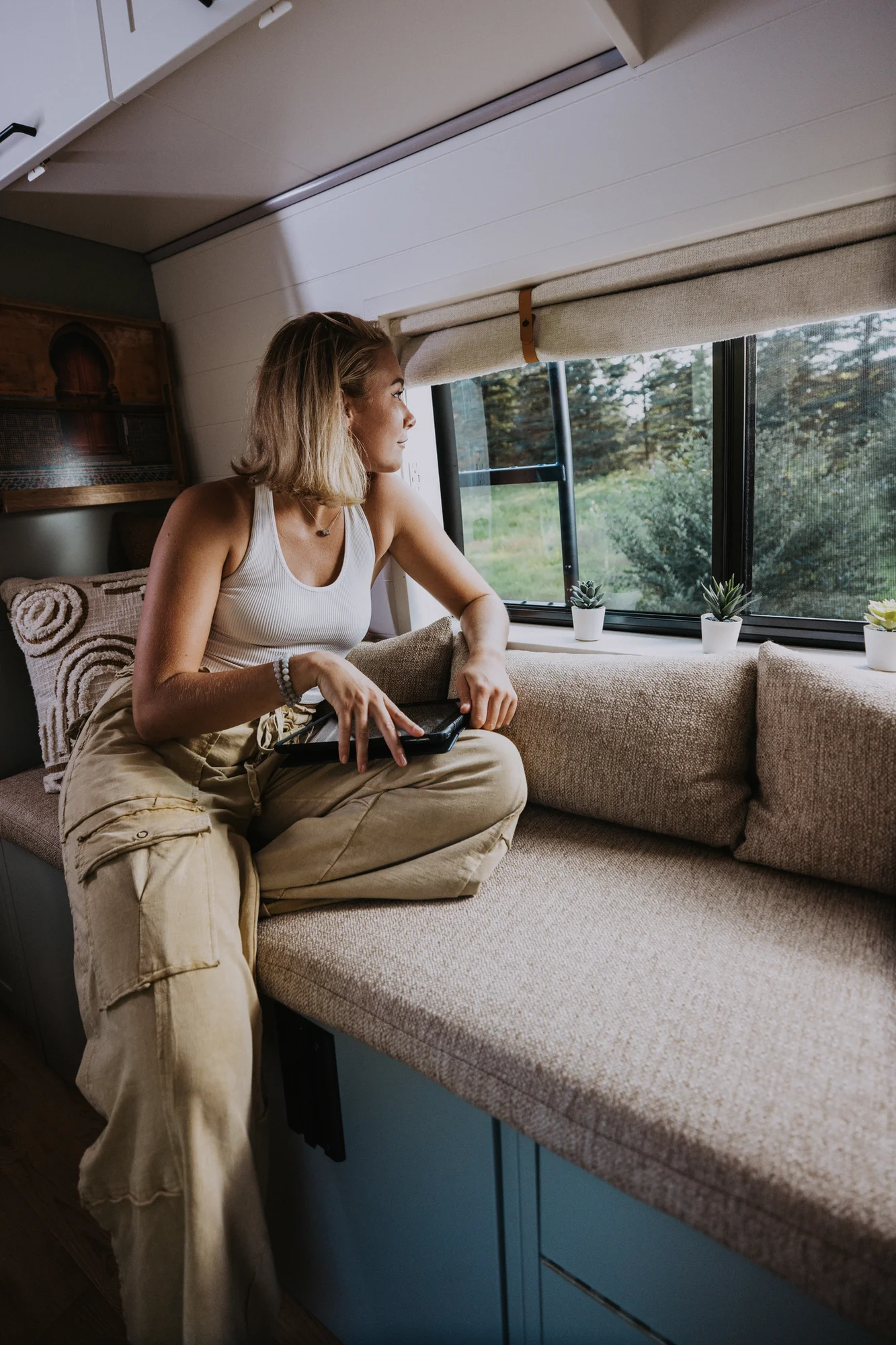 The Drifter 101 custom Ford Transit campervan built for Judy by Drifter Vans, Drifter layout with a boho interior, white oak butcher block, Honey Onix tile backsplash, and Avalanche Grey exterior