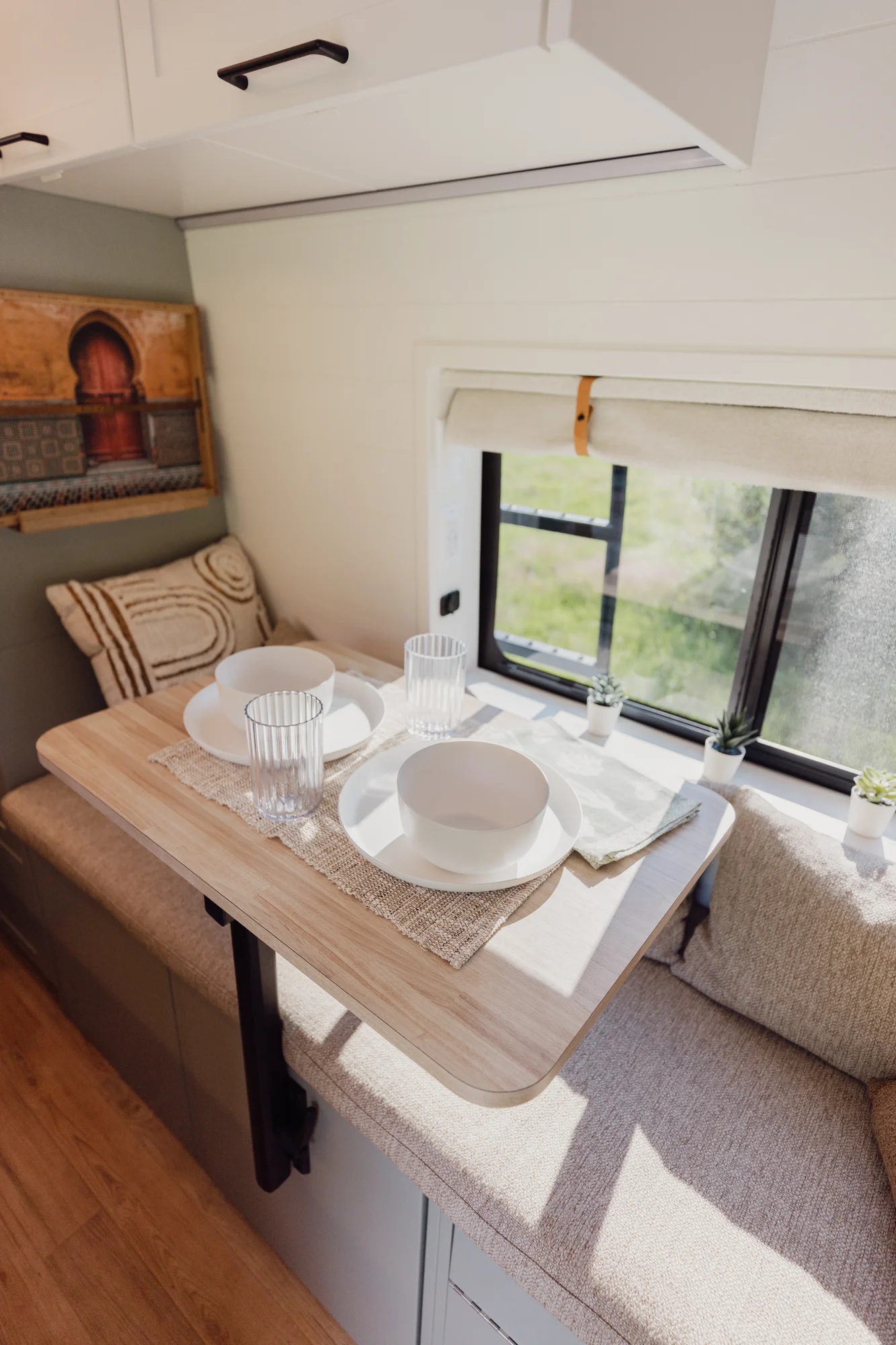 The Drifter 101 custom Ford Transit campervan built for Judy by Drifter Vans, Drifter layout with a boho interior, white oak butcher block, Honey Onix tile backsplash, and Avalanche Grey exterior