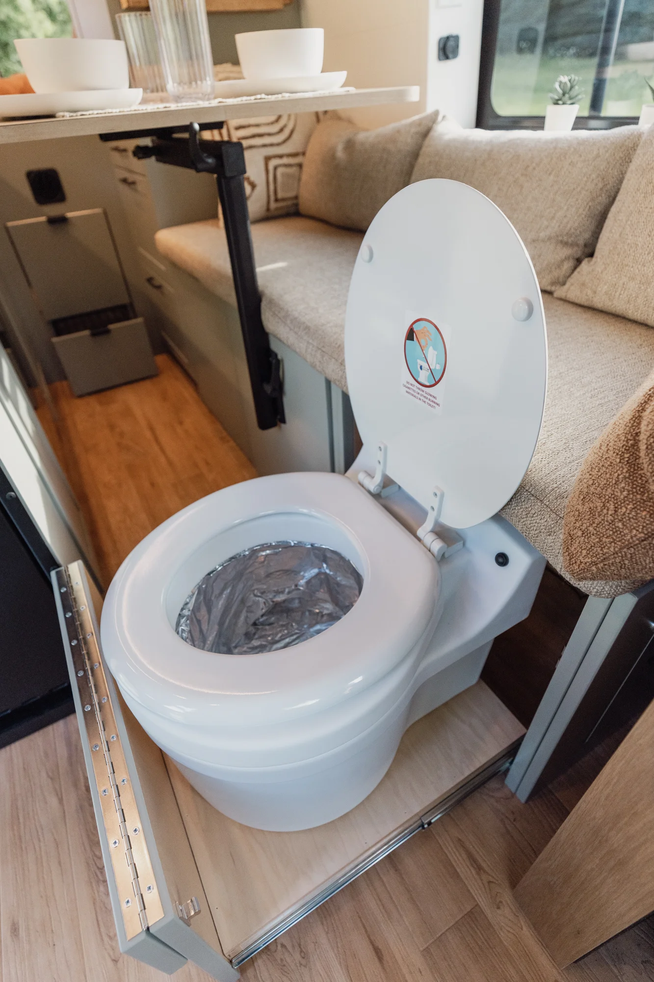 The Drifter 101 custom Ford Transit campervan built for Judy by Drifter Vans, Drifter layout with a boho interior, white oak butcher block, Honey Onix tile backsplash, and Avalanche Grey exterior