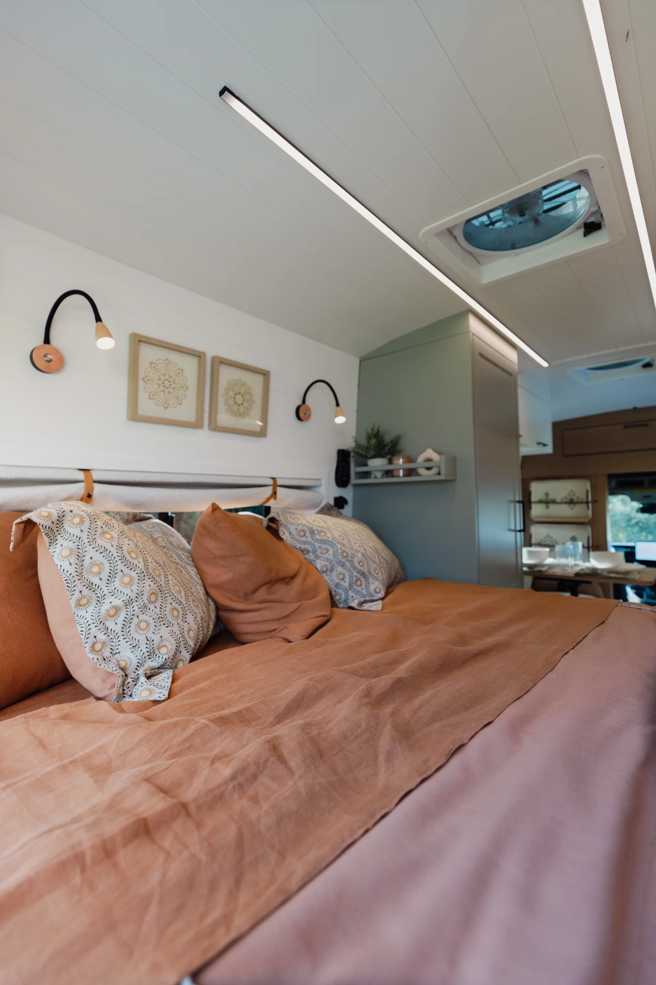 The Drifter 101 custom Ford Transit campervan built for Judy by Drifter Vans, Drifter layout with a boho interior, white oak butcher block, Honey Onix tile backsplash, and Avalanche Grey exterior