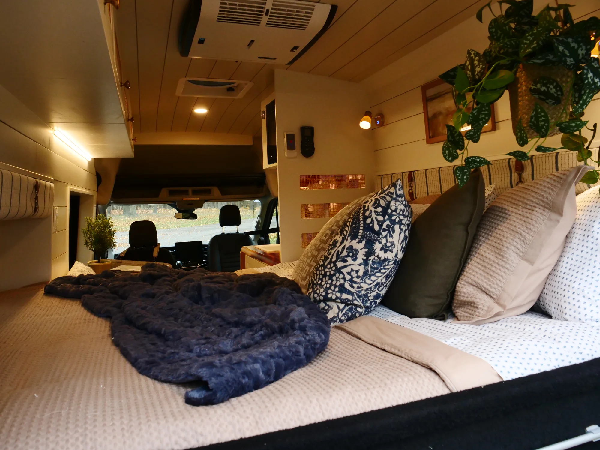 The Drifter 101 custom Ford Transit campervan built for Lori by Drifter Vans, Wanderer layout with a modern farmhouse interior, maple butcher block countertop, gold fixtures, and an exterior FVCO roof rack and ladder