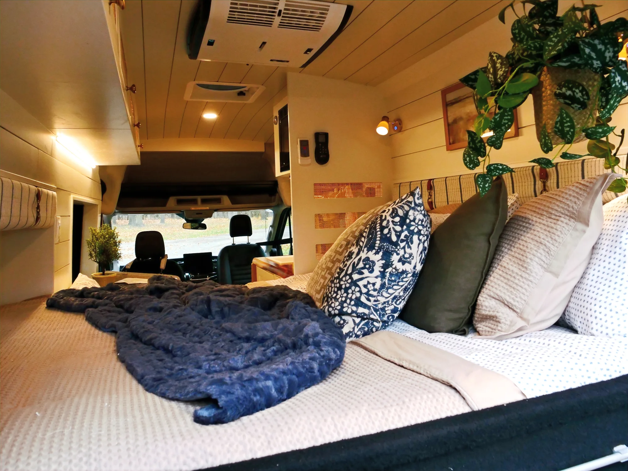 The Drifter 101 custom Ford Transit campervan built for Lori by Drifter Vans, Wanderer layout with a modern farmhouse interior, maple butcher block countertop, gold fixtures, and an exterior FVCO roof rack and ladder