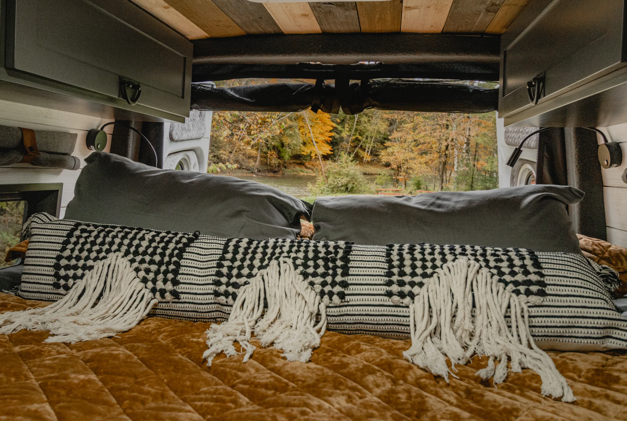 The Drifter 101 custom Mercedes-Benz Sprinter campervan built for Roger and Melisa by Drifter Vans, with a porthole wood shower door, dark wood interior, Southwest-style backsplash, and cast iron hardware
