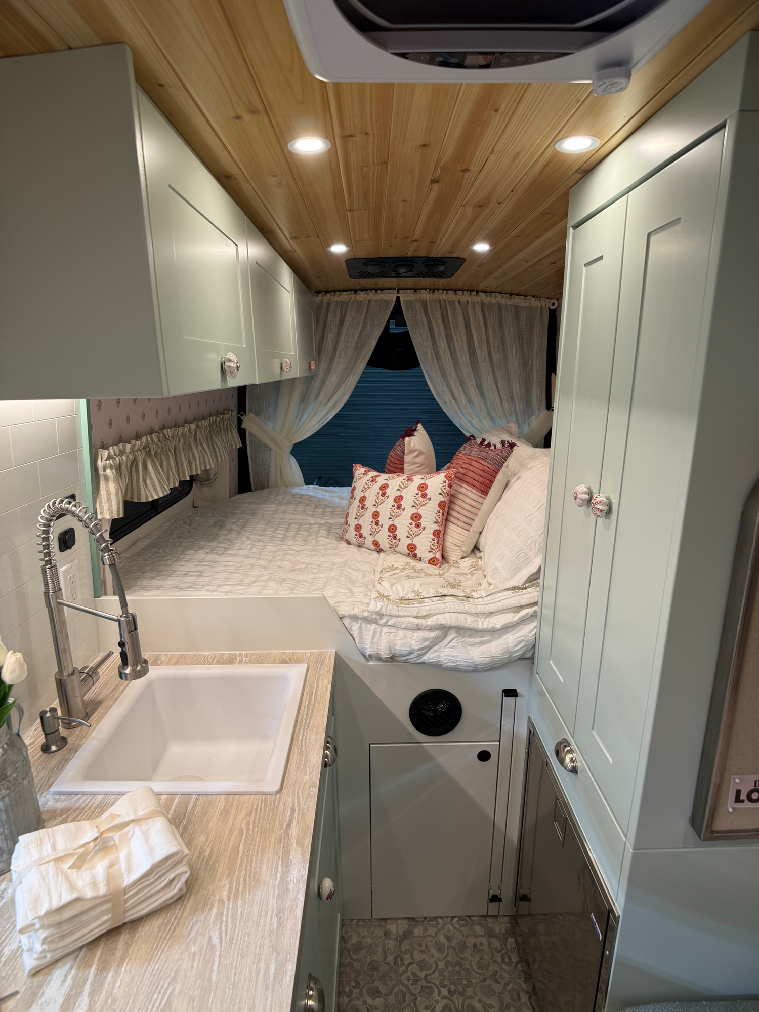 The Drifter 101 custom Ford Transit campervan built for Lori Smith by Drifter Vans, Drifter layout with a cottage garden-inspired interior, handcrafted cabinetry, and custom luxury finishes
