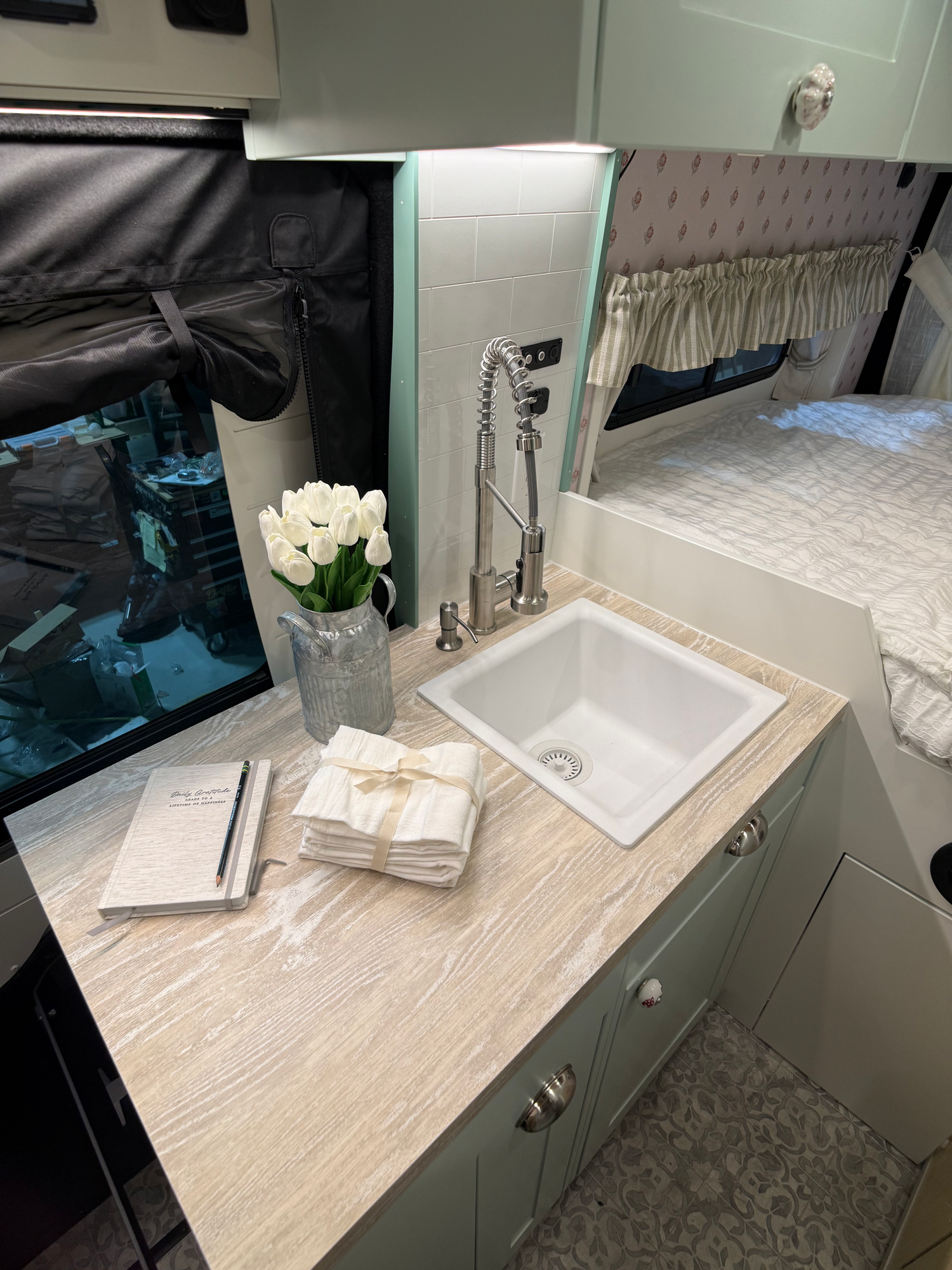 The Drifter 101 custom Ford Transit campervan built for Lori Smith by Drifter Vans, Drifter layout with a cottage garden-inspired interior, handcrafted cabinetry, and custom luxury finishes