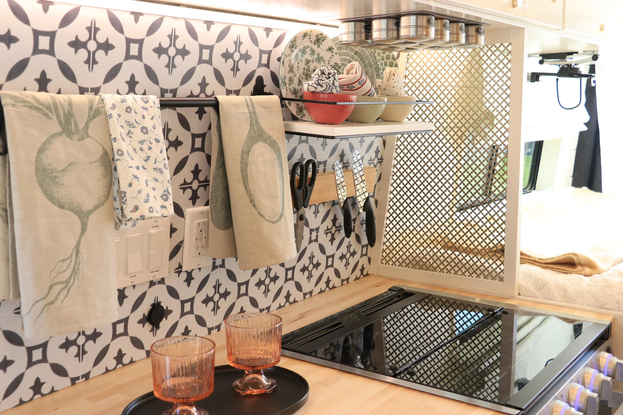 The Drifter 101 custom Mercedes-Benz Sprinter campervan built for Suzzane by Drifter Vans, with geometric patterned tile, sage green seating, white shiplap walls, and brass fixtures
