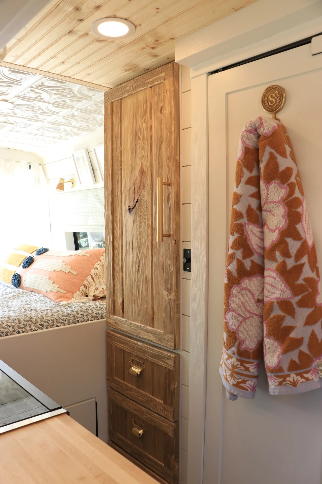 The Drifter 101 custom Mercedes-Benz Sprinter campervan built for Suzzane by Drifter Vans, with geometric patterned tile, sage green seating, white shiplap walls, and brass fixtures