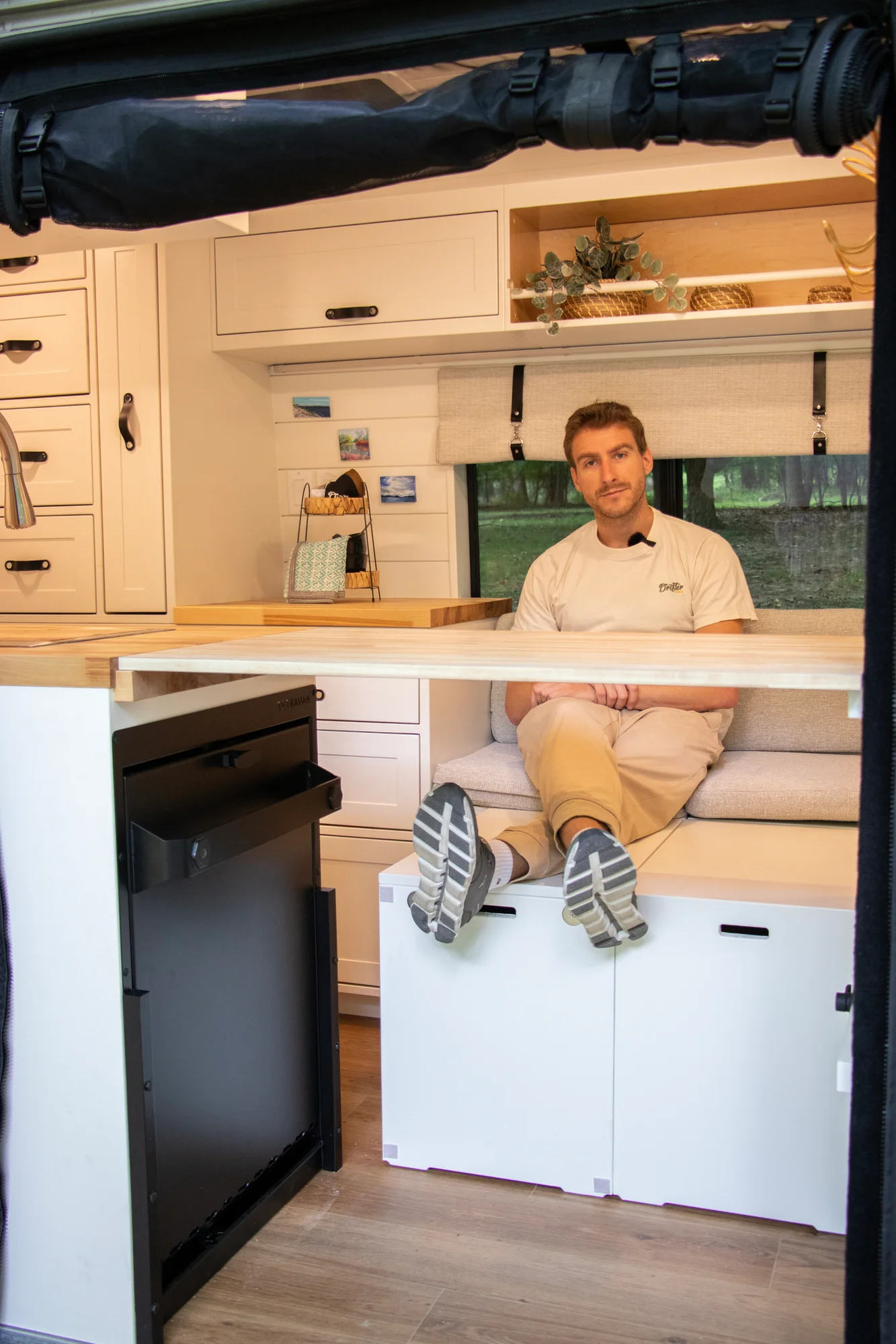 The Drifter 101 custom Ram ProMaster campervan built for Diane by Drifter Vans, with white cabinetry, butcher block countertop, a convertible bed system, and coastal accents