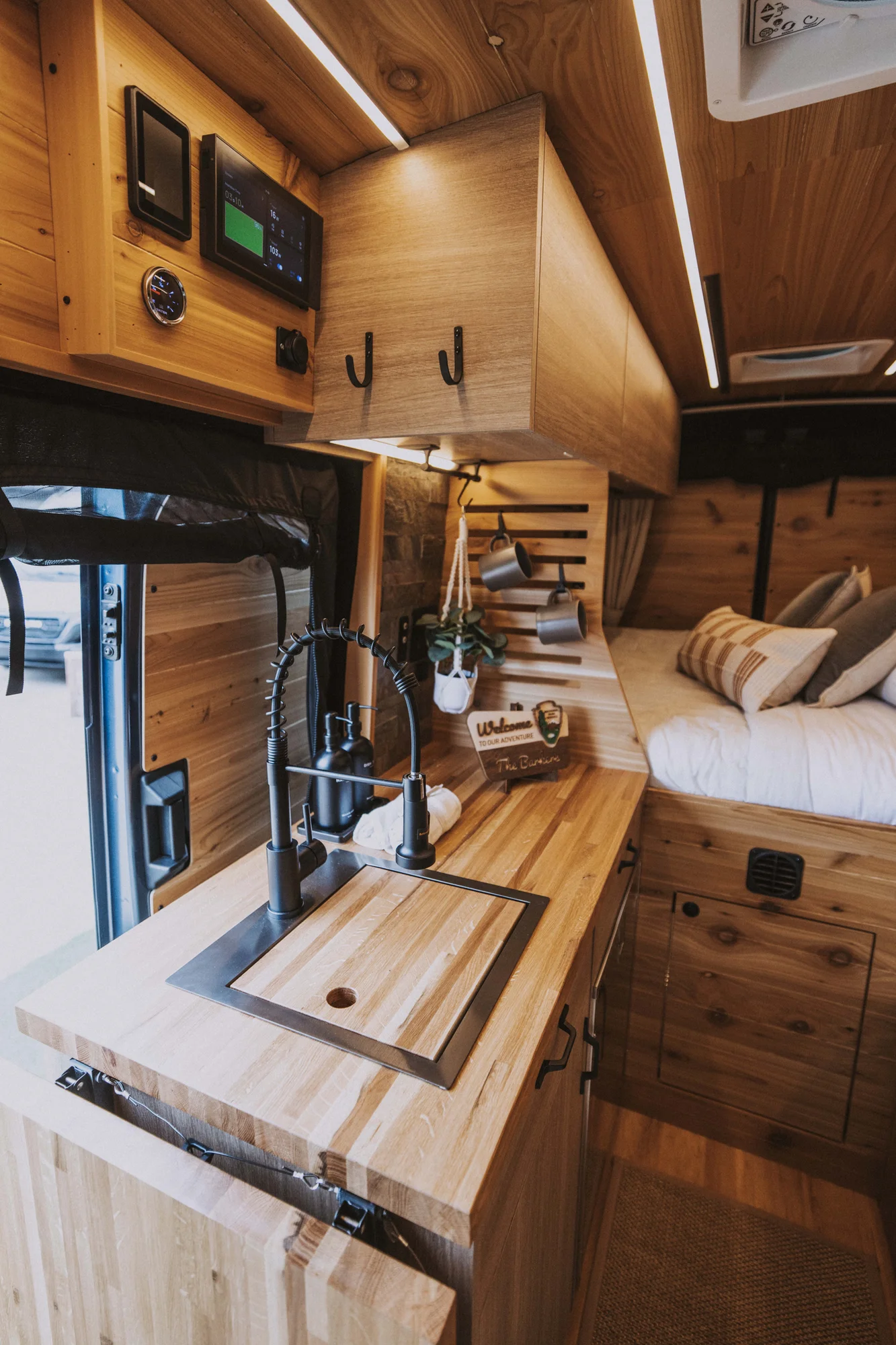The Drifter 101 custom Ford Transit campervan built for Ken and Terry by Drifter Vans, with cedar plank walls, ambient lighting, and a compact dinette