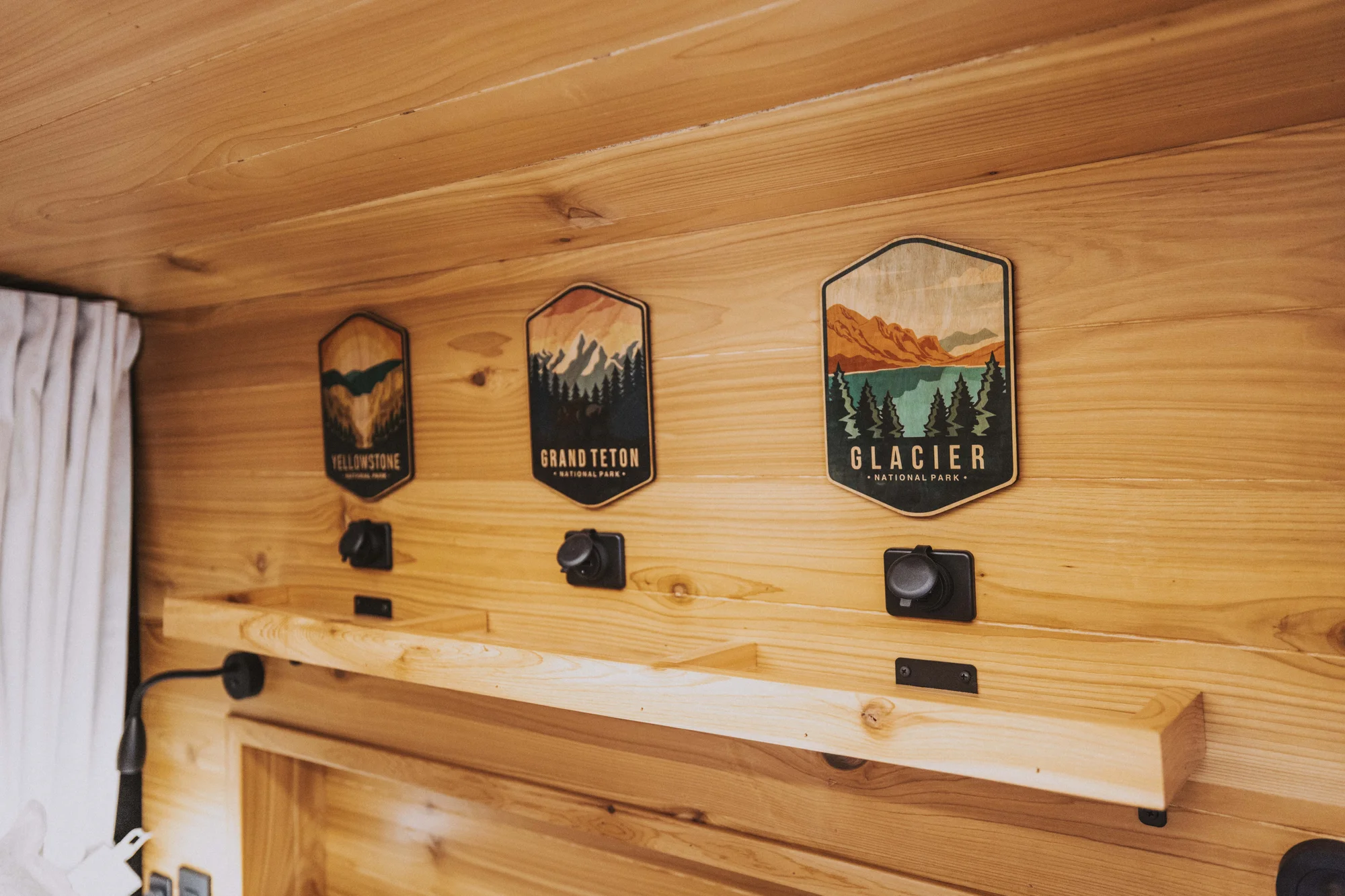 The Drifter 101 custom Ford Transit campervan built for Ken and Terry by Drifter Vans, with cedar plank walls, ambient lighting, and a compact dinette