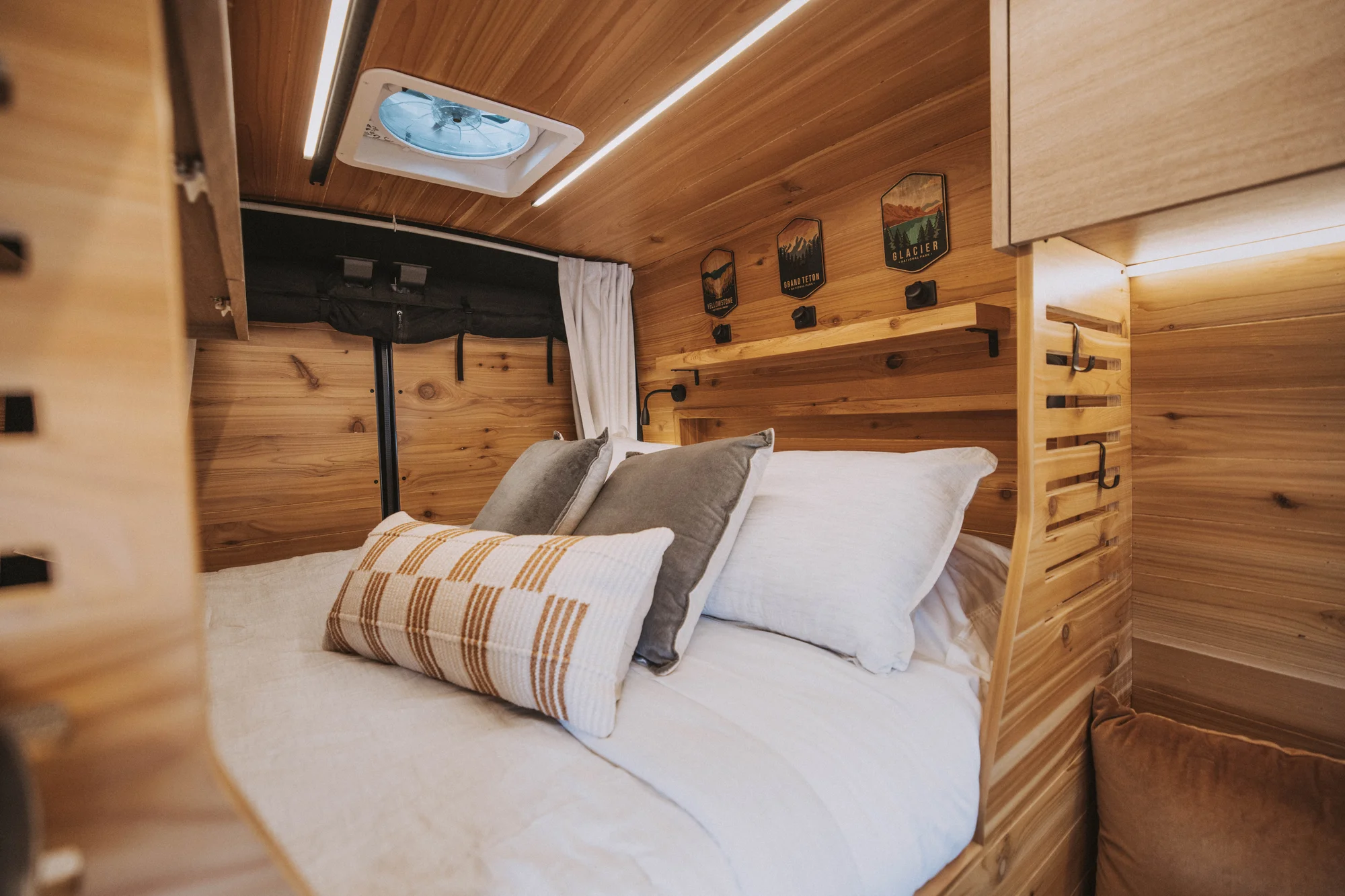The Drifter 101 custom Ford Transit campervan built for Ken and Terry by Drifter Vans, with cedar plank walls, ambient lighting, and a compact dinette
