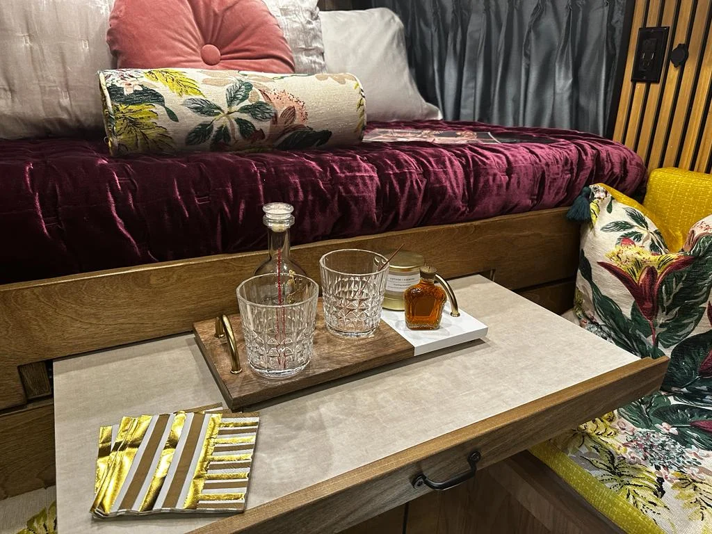 The Drifter 101 custom Ram ProMaster campervan built for Stephanie by Drifter Vans, Nomadik layout with a retro interior, velvet bedding, floral textiles, and brass fixtures