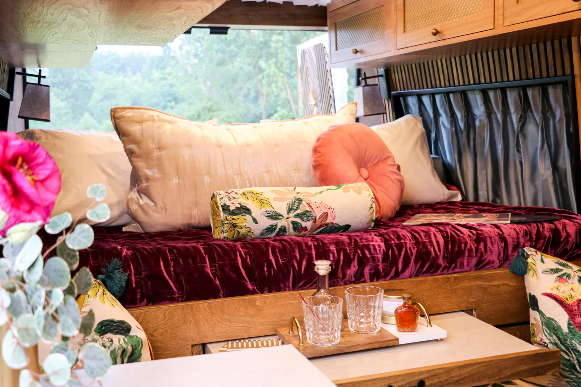 The Drifter 101 custom Ram ProMaster campervan built for Stephanie by Drifter Vans, Nomadik layout with a retro interior, velvet bedding, floral textiles, and brass fixtures
