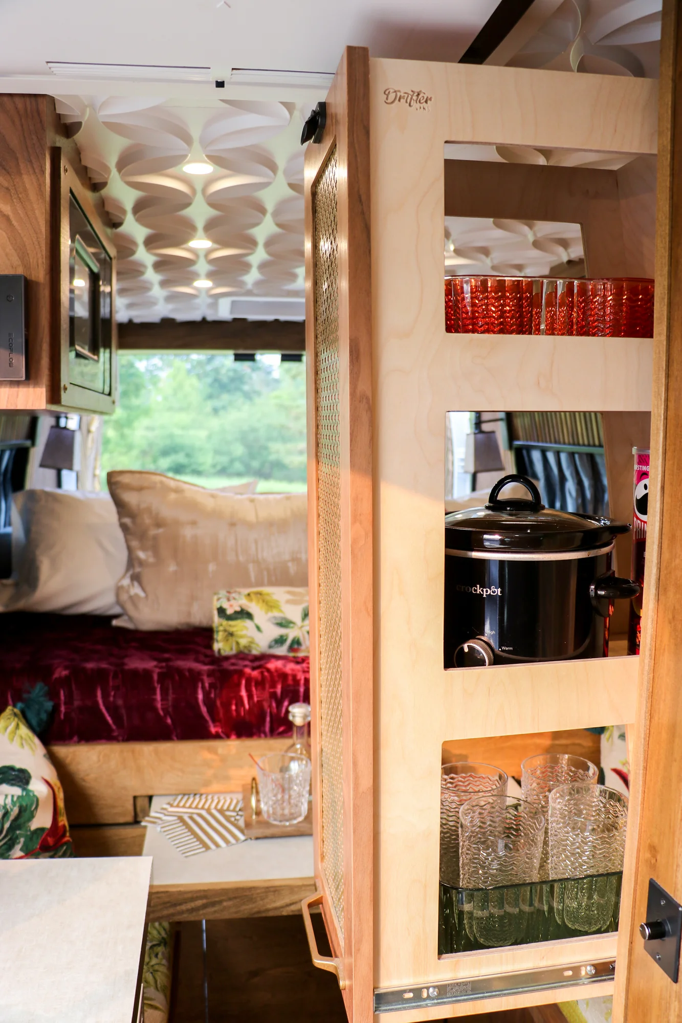 The Drifter 101 custom Ram ProMaster campervan built for Stephanie by Drifter Vans, Nomadik layout with a retro interior, velvet bedding, floral textiles, and brass fixtures