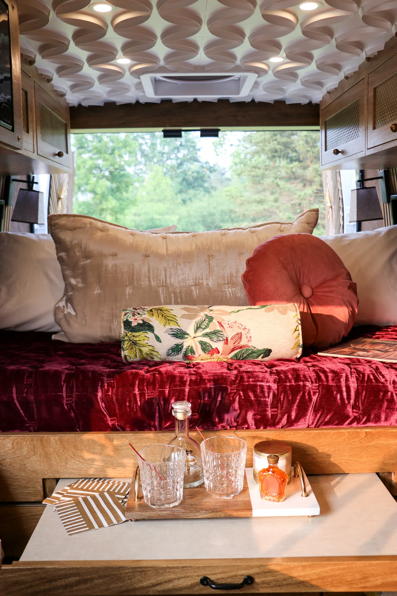 The Drifter 101 custom Ram ProMaster campervan built for Stephanie by Drifter Vans, Nomadik layout with a retro interior, velvet bedding, floral textiles, and brass fixtures